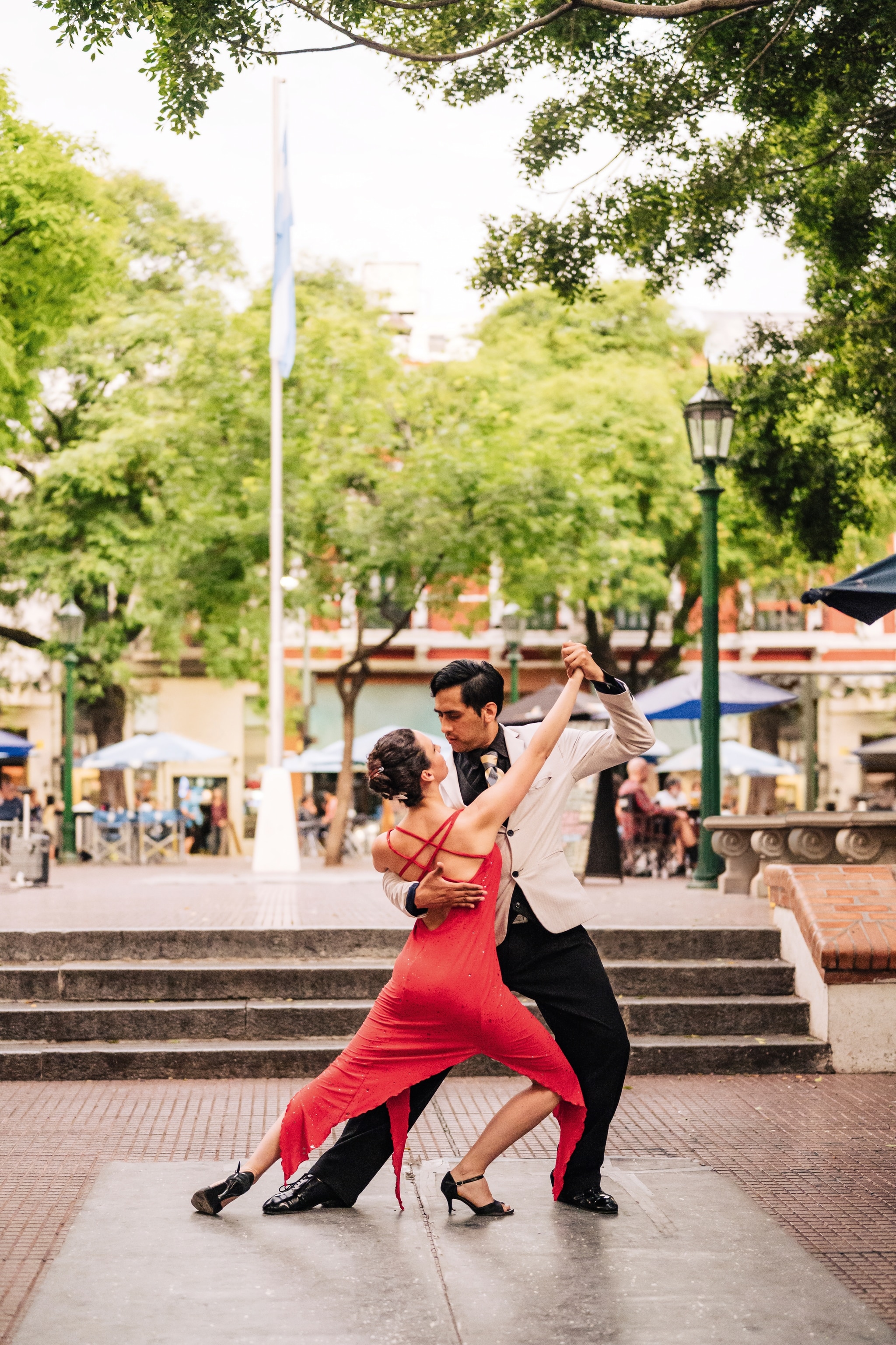 Tango dancers, one in a red dress, one in a suit