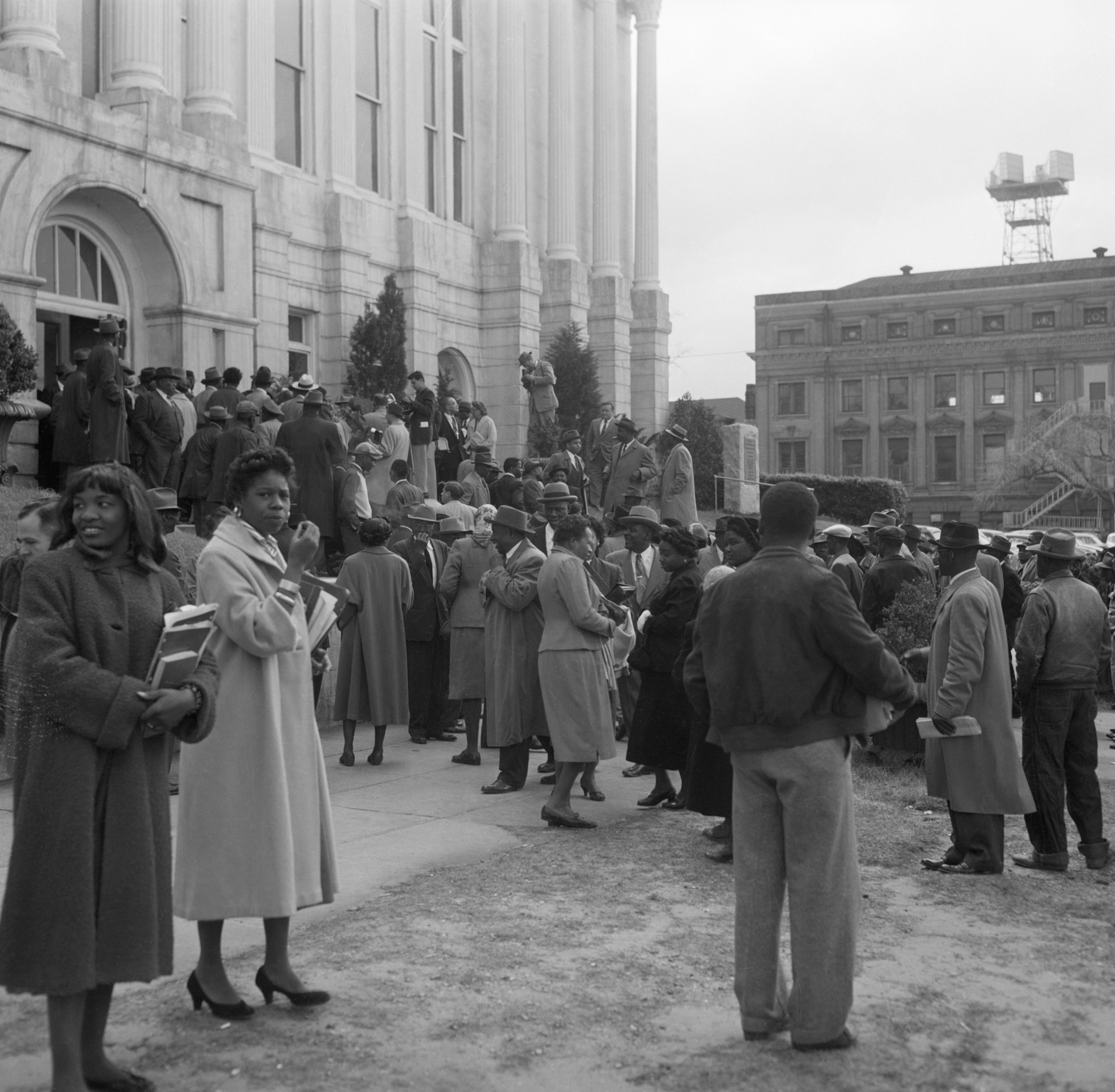 A crowd of African Americans gathered outside a courthouse
