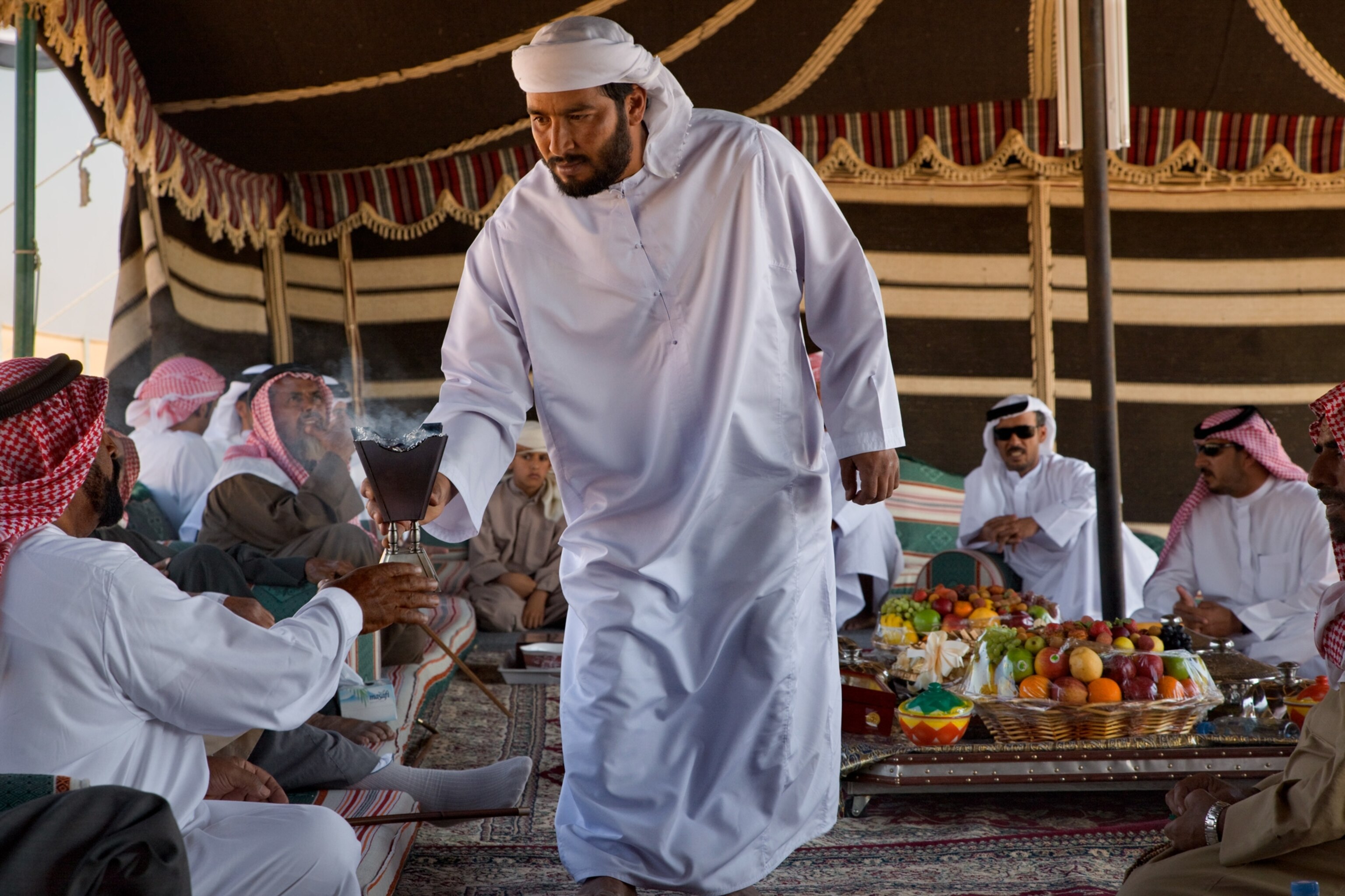 men gathered to share fruit, drink tea and coffee, and socialize the old-fashioned way