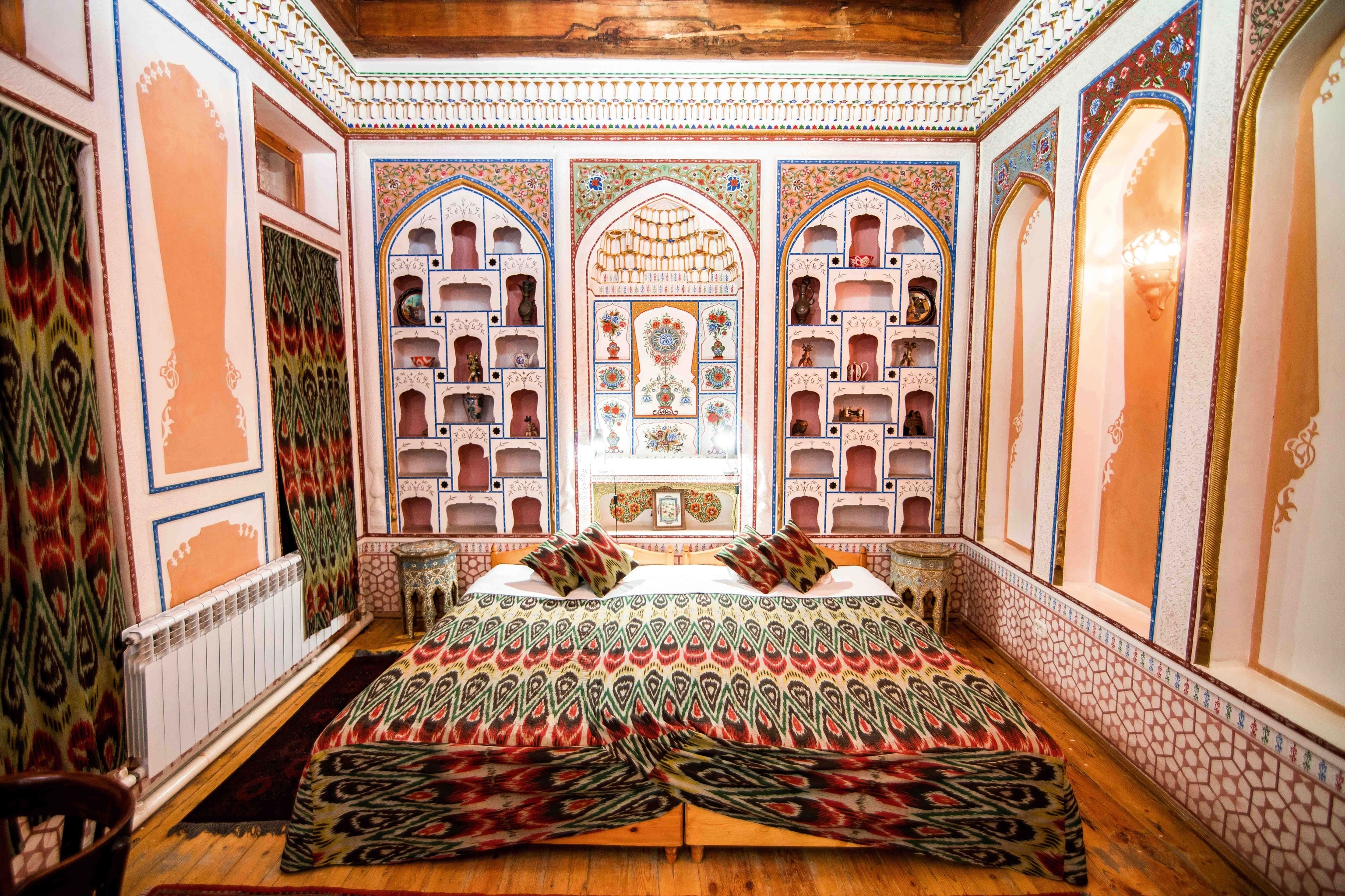 A hotel room with decorative walls in Bukhara