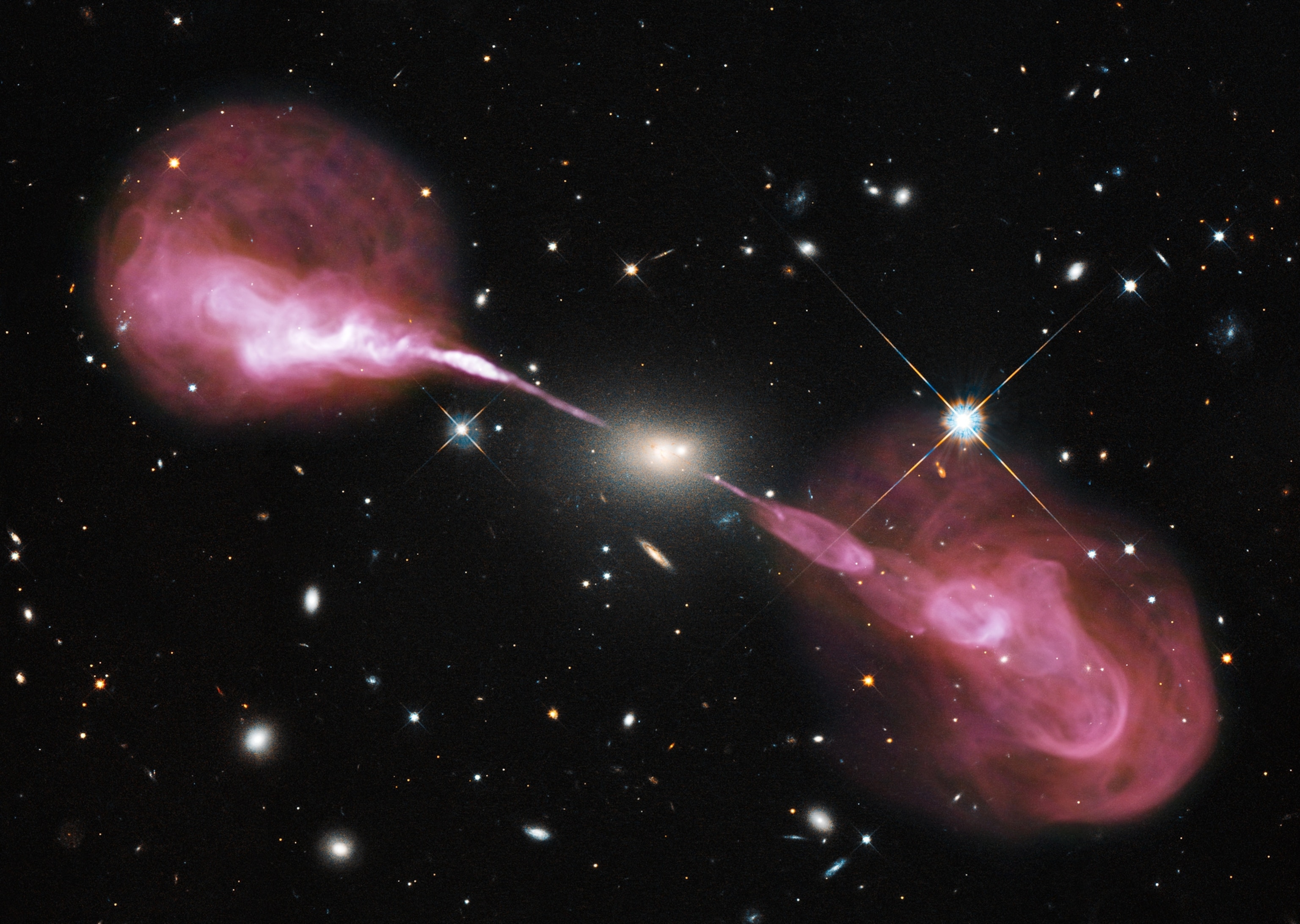 Telescope picture of jets of material shooting from a supermassive black hole in the Hercules A galaxy