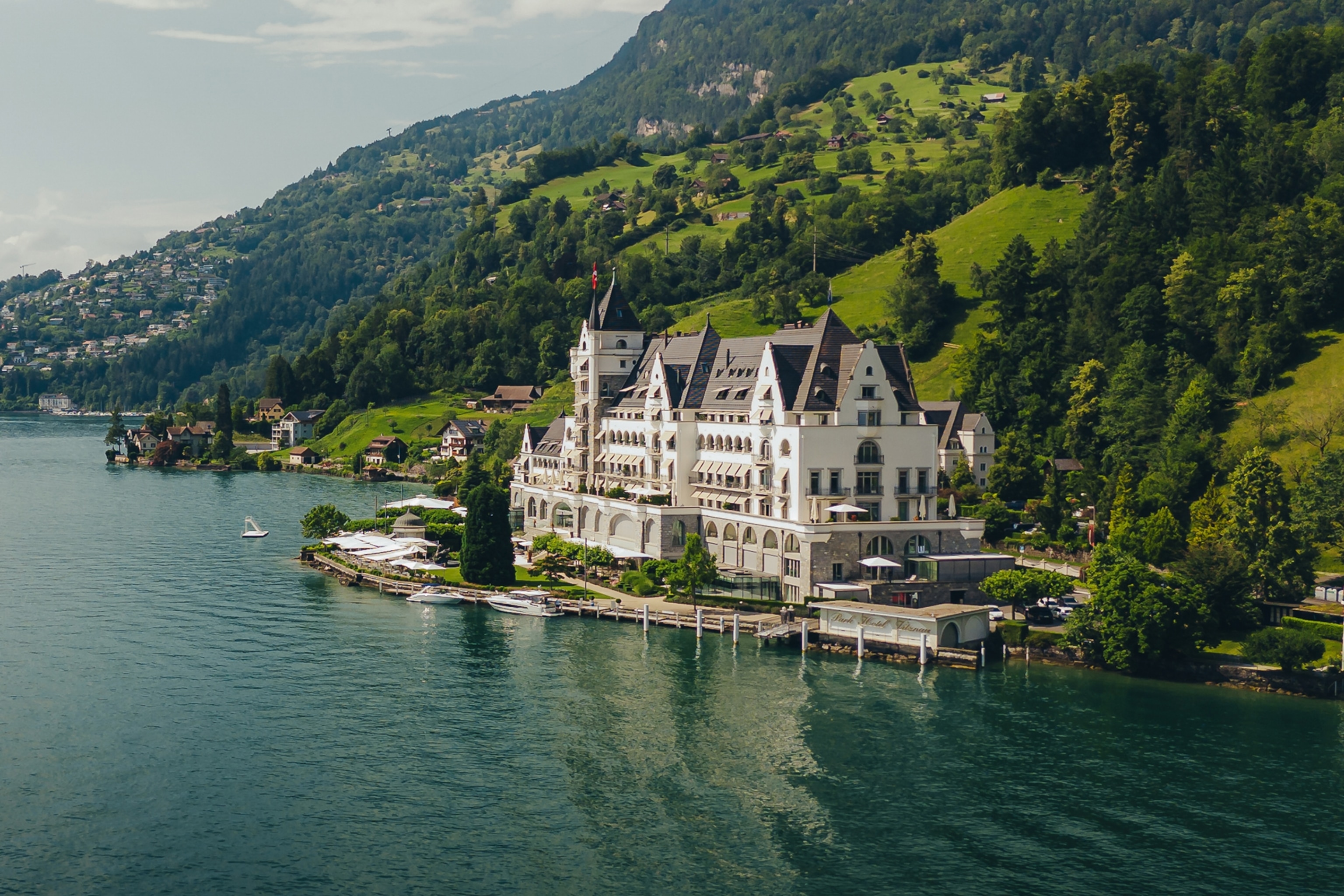 A grand villa on the shores of a lake in Switzerland.
