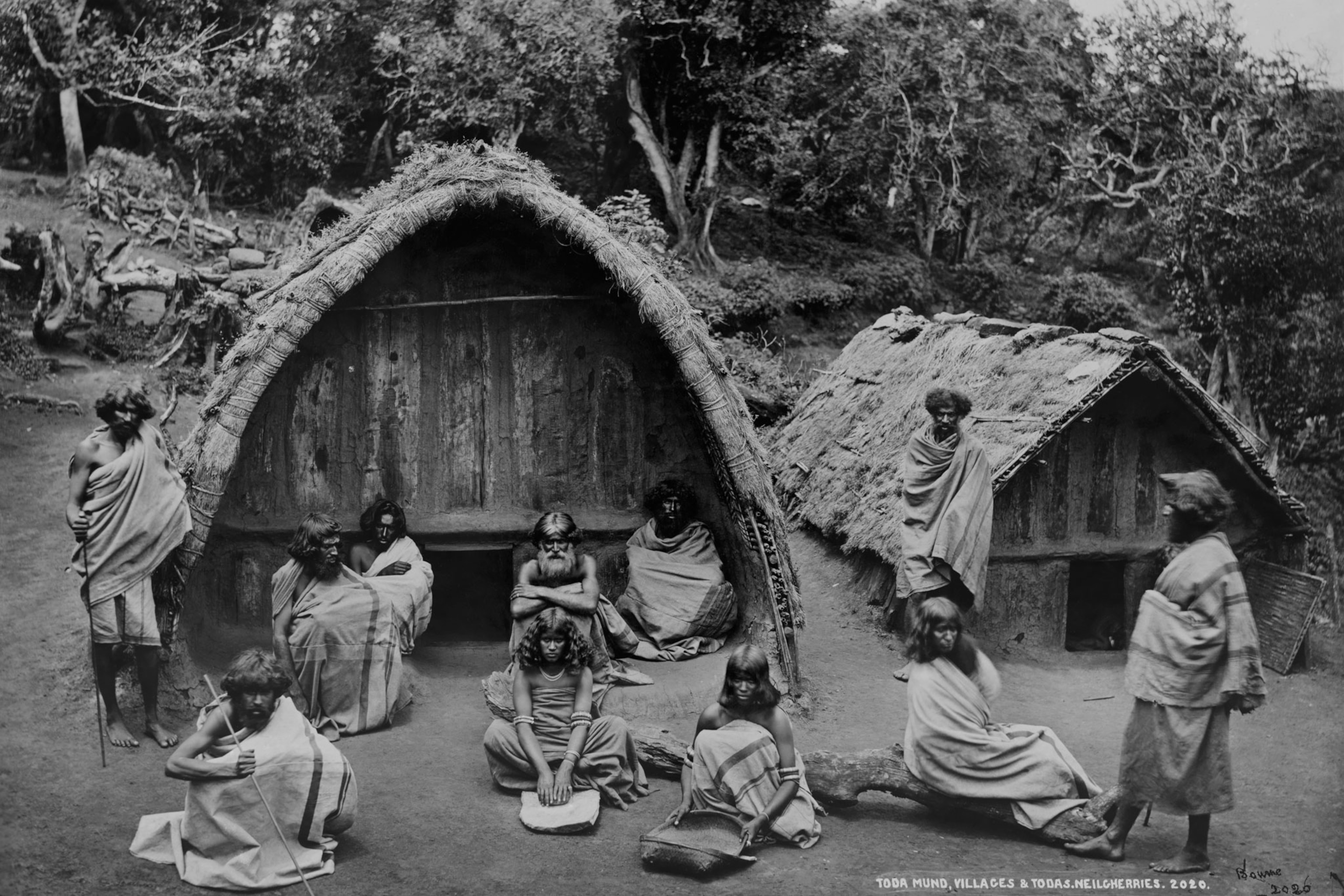 a group of men and women outside their homes in India