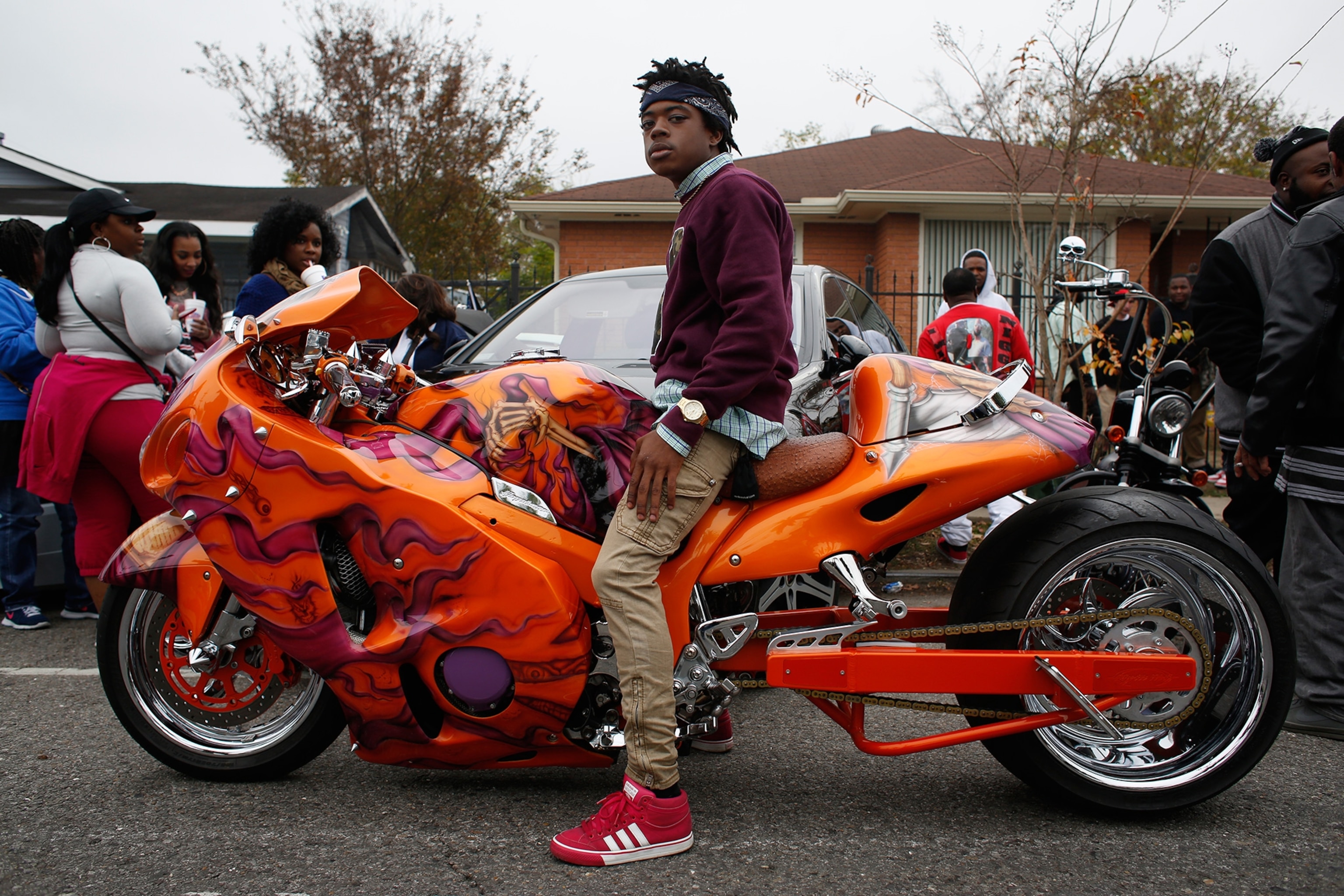 a young man on an elaborately decorated motorcycle along the Big Nine's parade route in New Orleans.