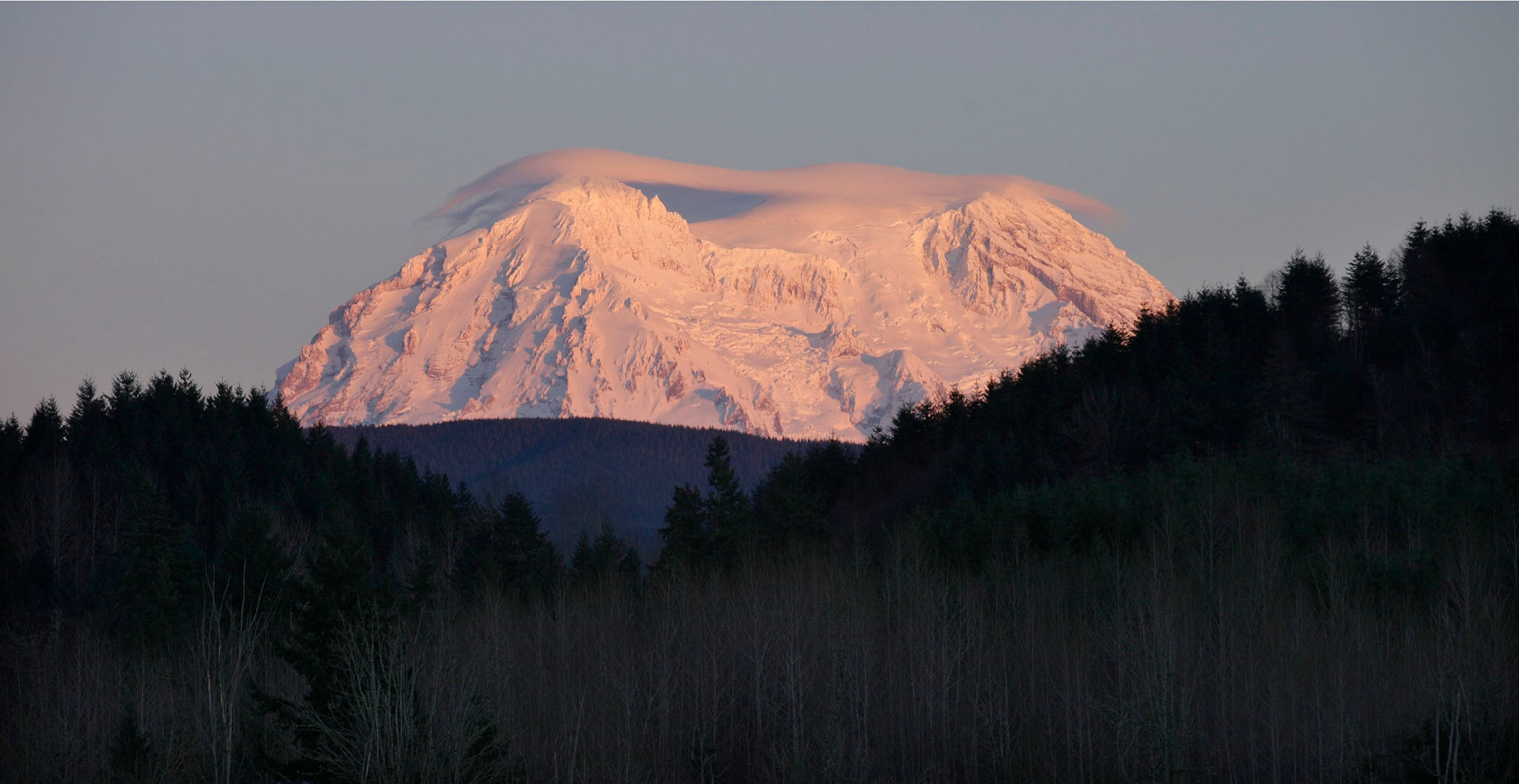 This Jan. 8, 2012 file photo shows Mount Rainier taking on a rosy glow near sunset as viewed from Eatonville, Wash. Mount Rainier National Park.