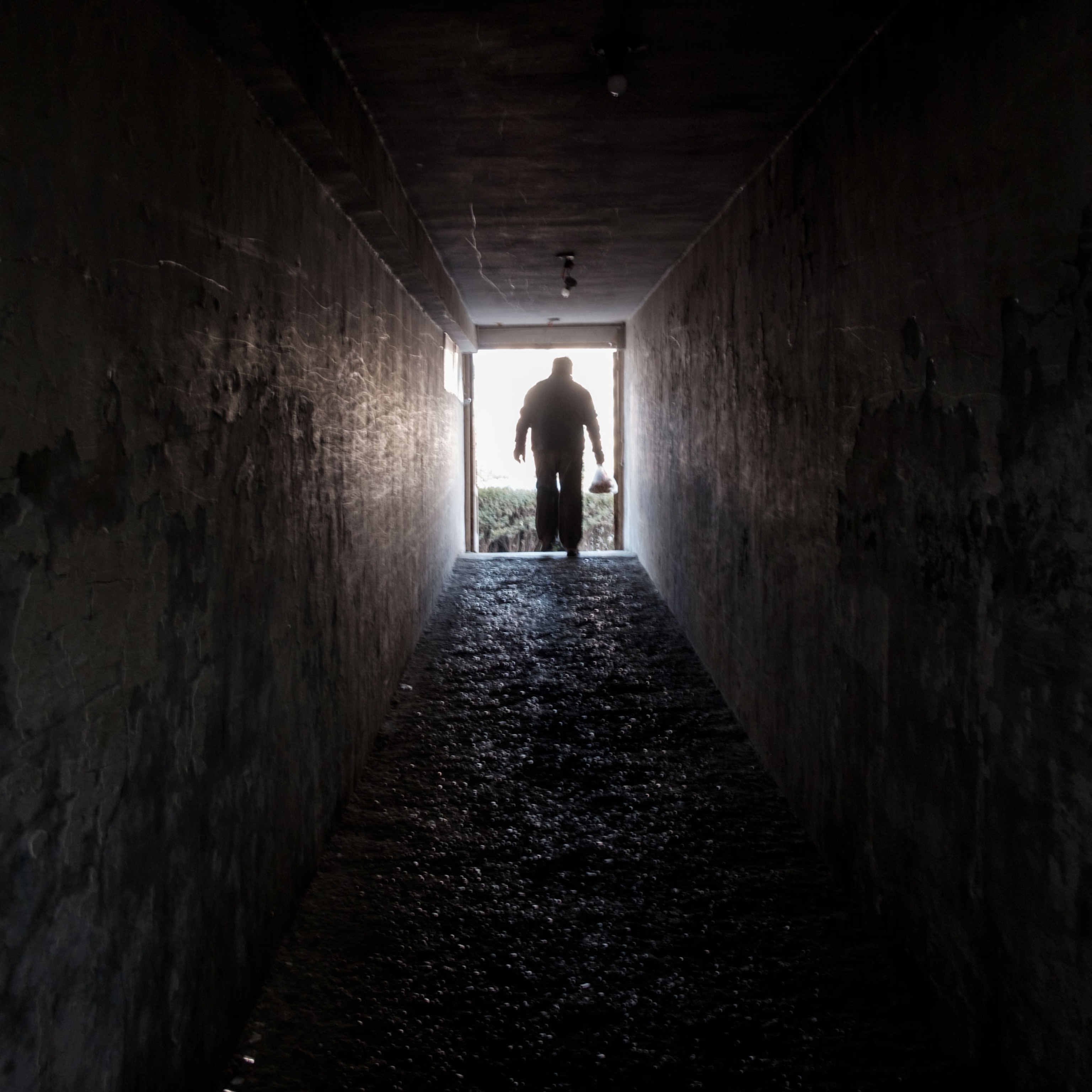 a man exiting a shelter