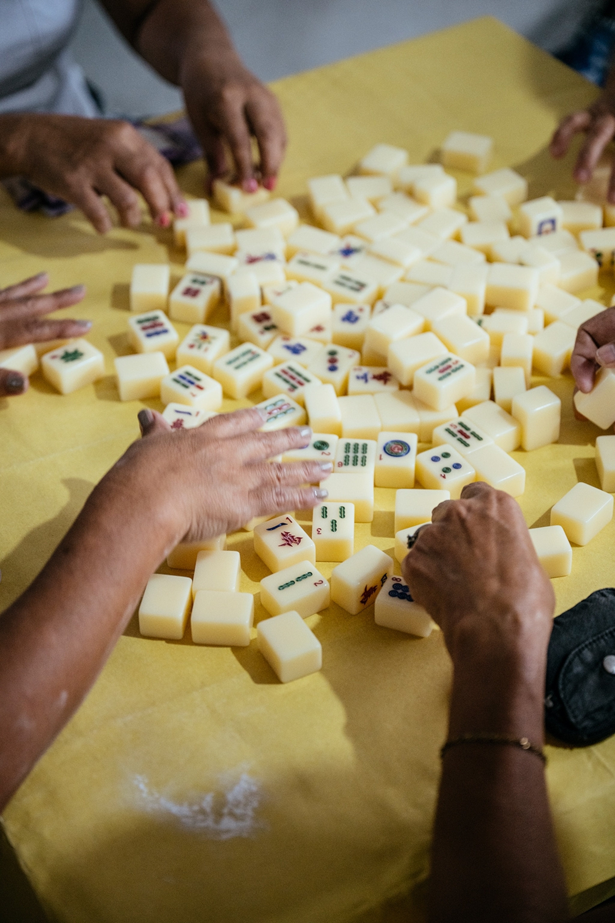 A dynamic shot of people playing mahjong.
