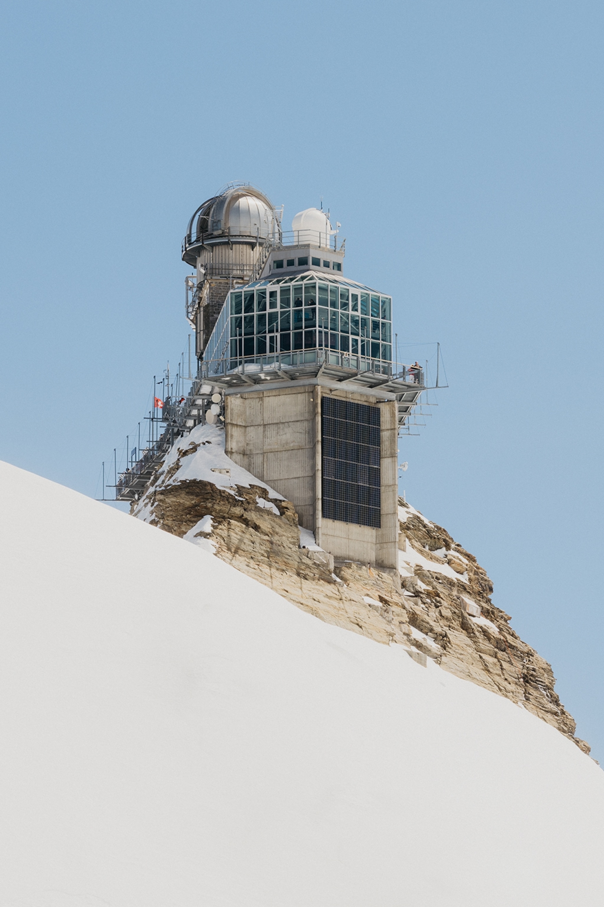 A research station with a small tower and a panorama viewing platform in the snow.