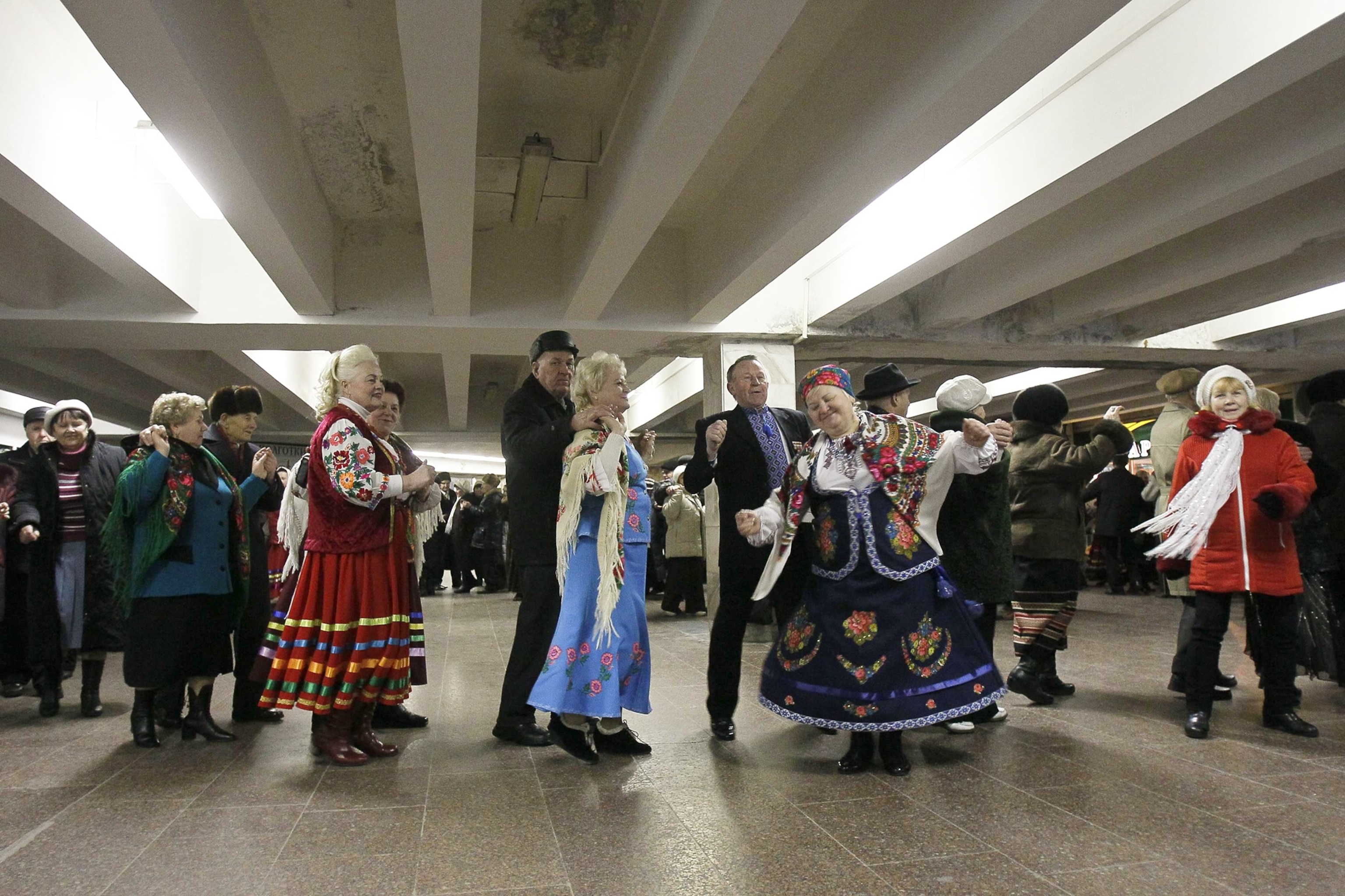 Elderly Ukrainians wearing traditional dress dance in subway station