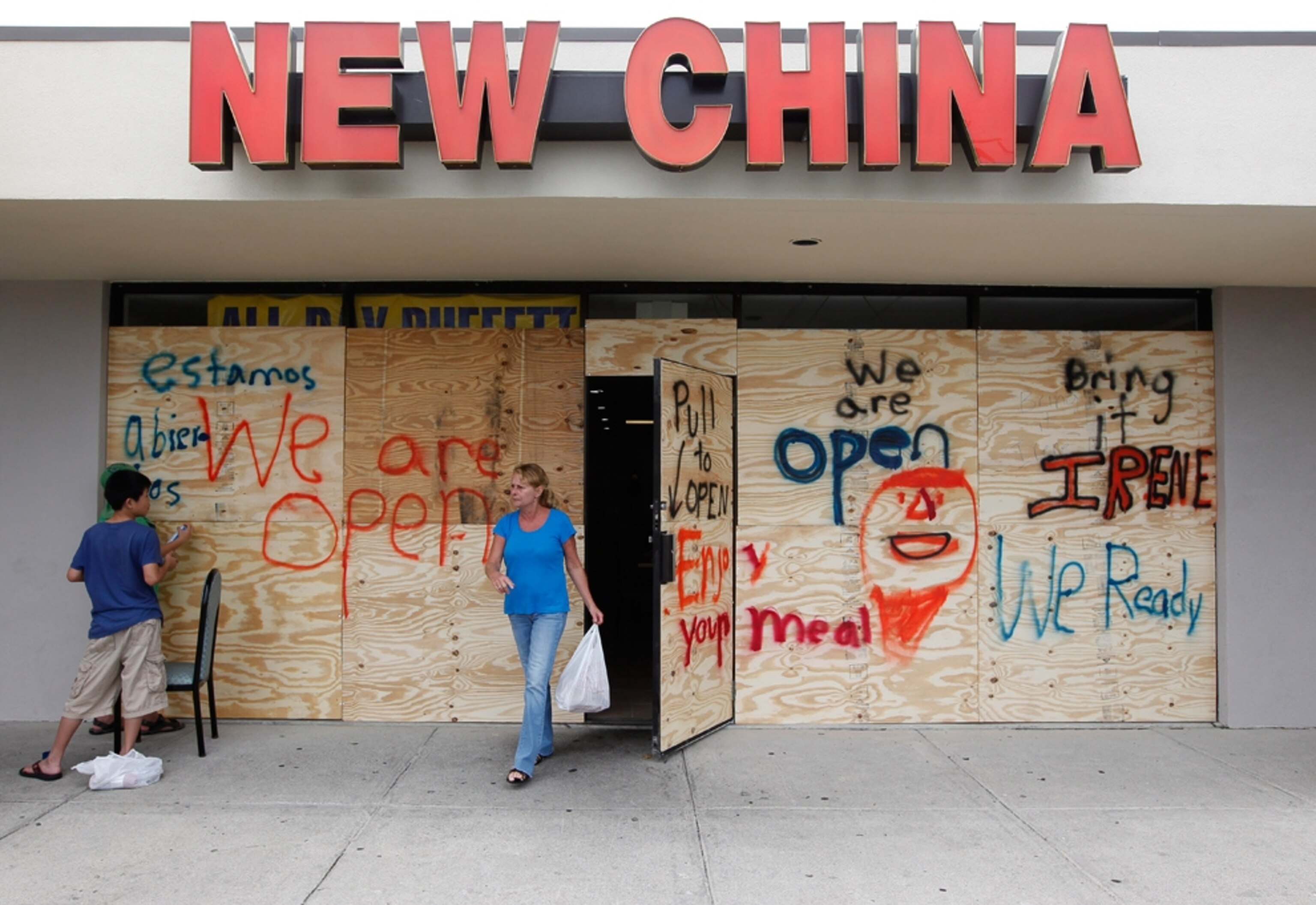 Hurricane Irene picture: a woman buys a Chinese takeout in preparation for the storm