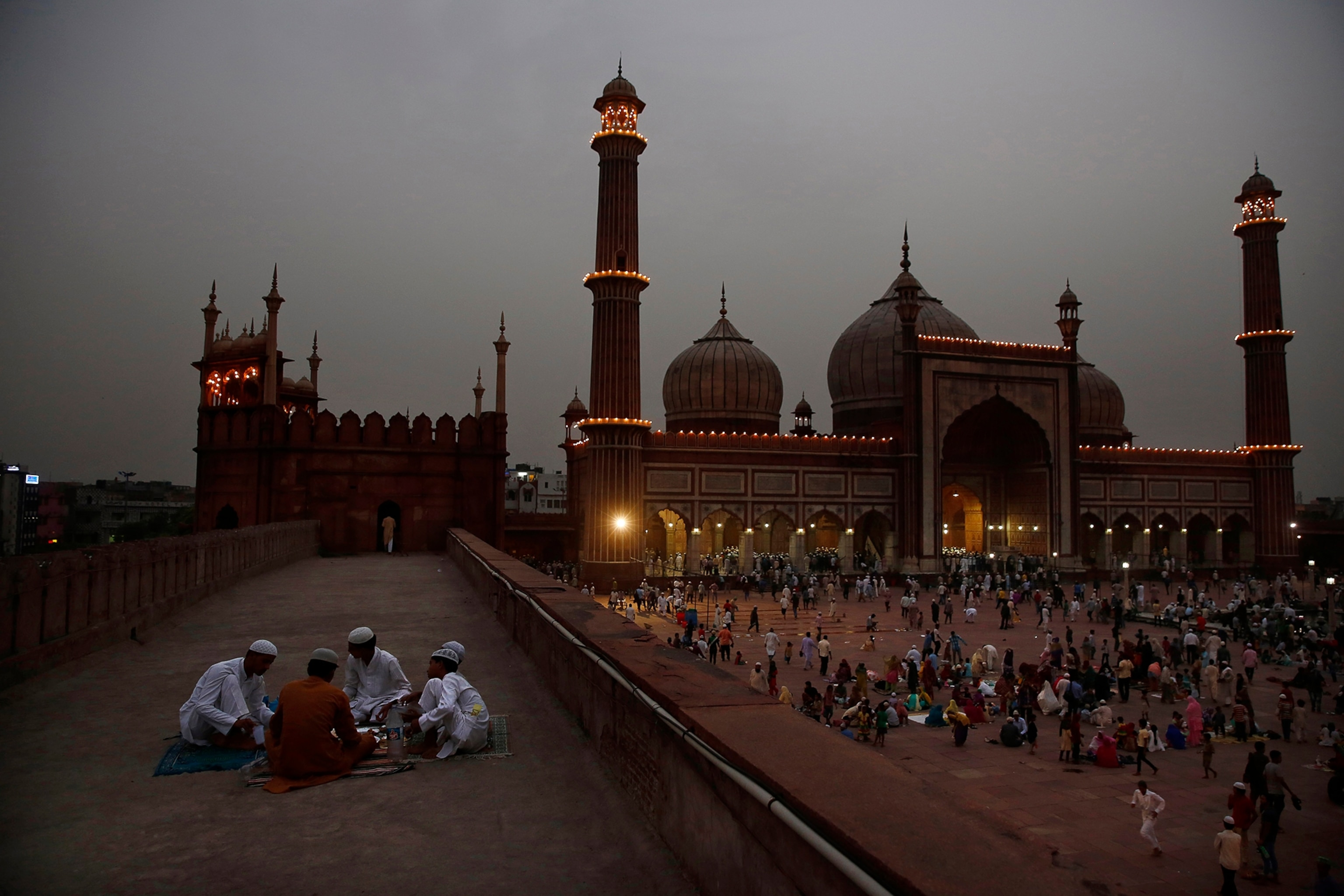 Indian Muslims break their fast on the first day of holy month Ramadan at the Jama Mosque in New Delhi, India, on Monday, June 30, 2014.
