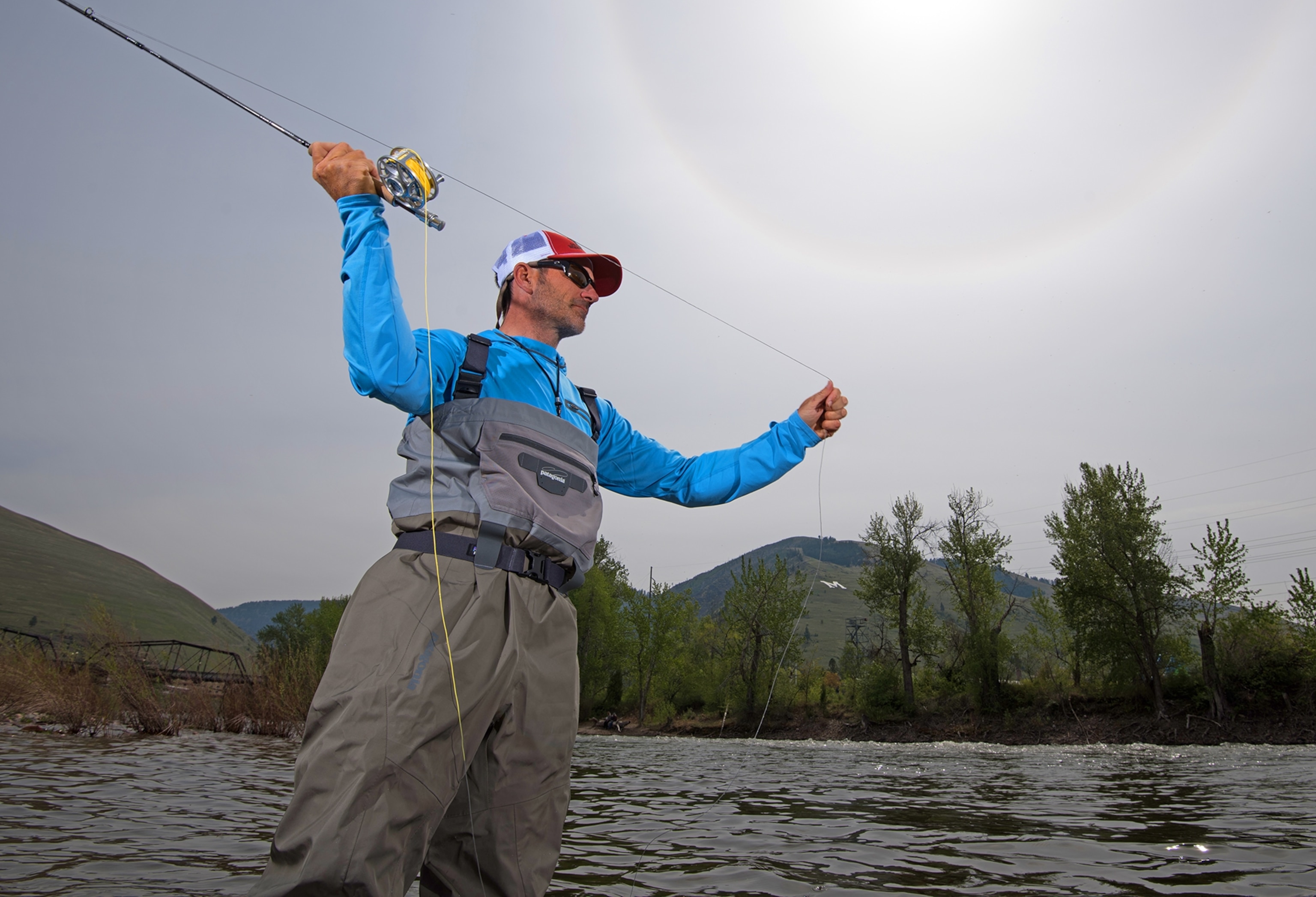 a fly fisherman casting his line in the Clark Fork River in Missoula, Montana