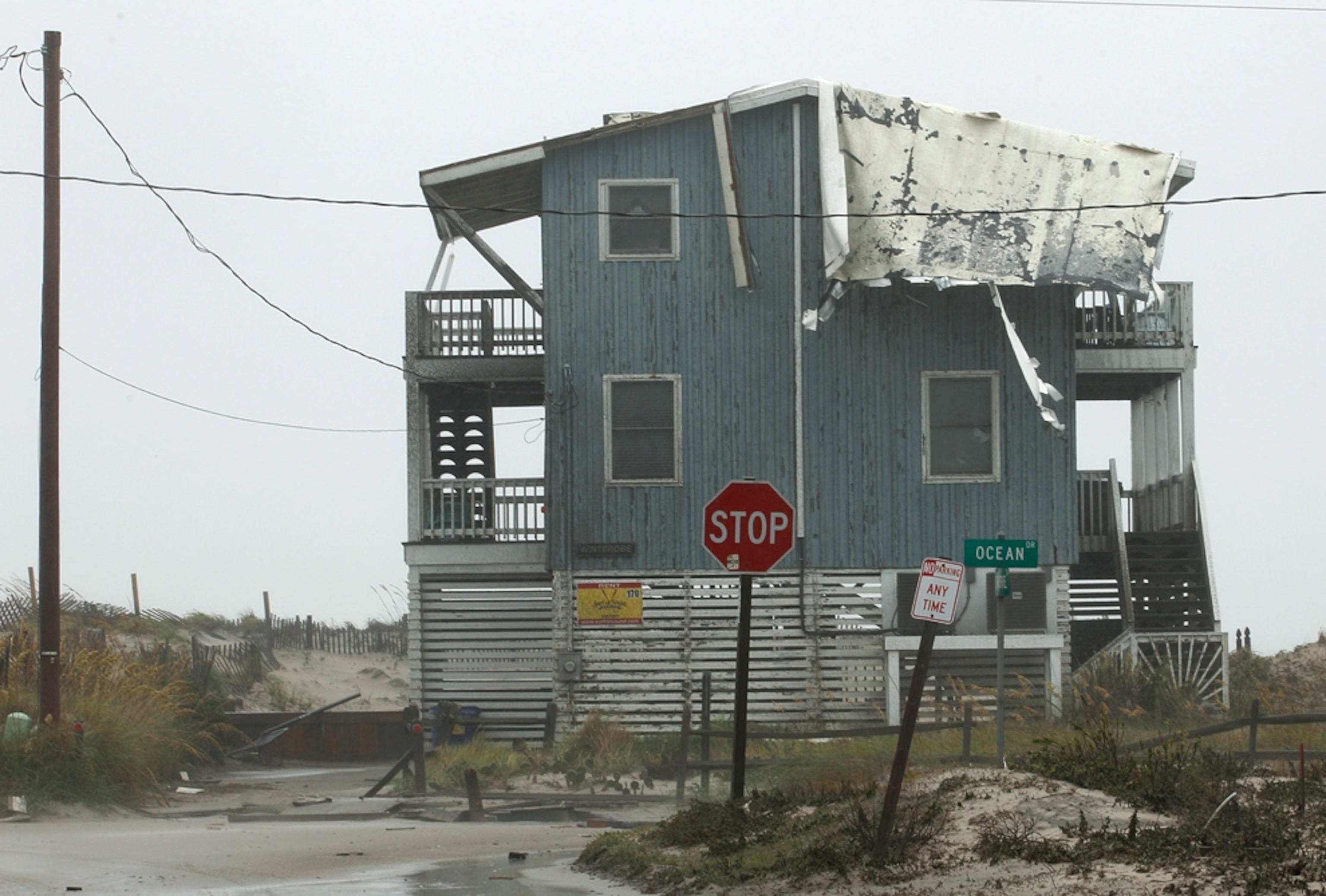 Hurricane Irene picture: a beach house with a roof destroyed by Hurricane Irene