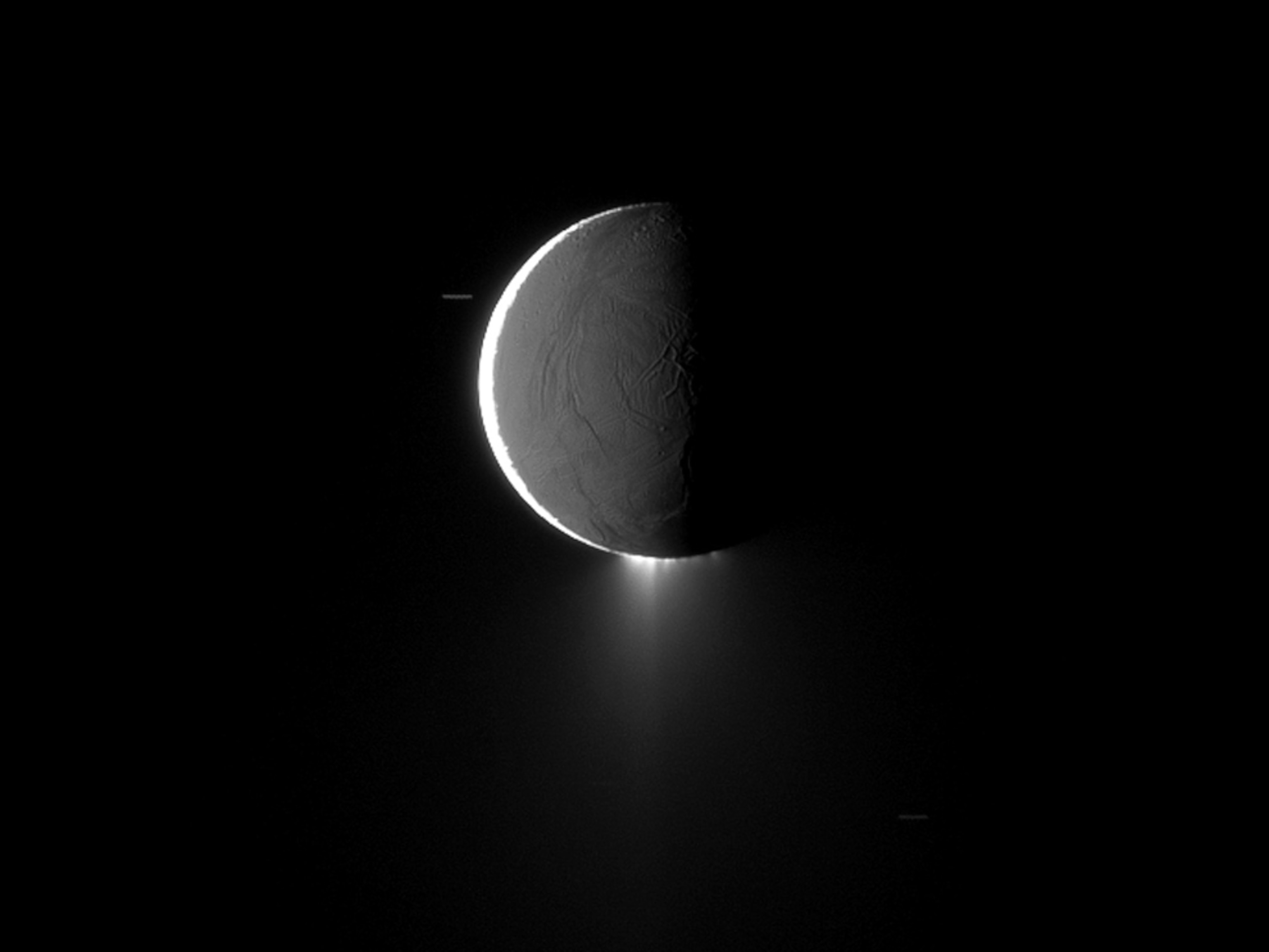 Saturn moon picture: Enceladus and its plumes backlighted by the sun