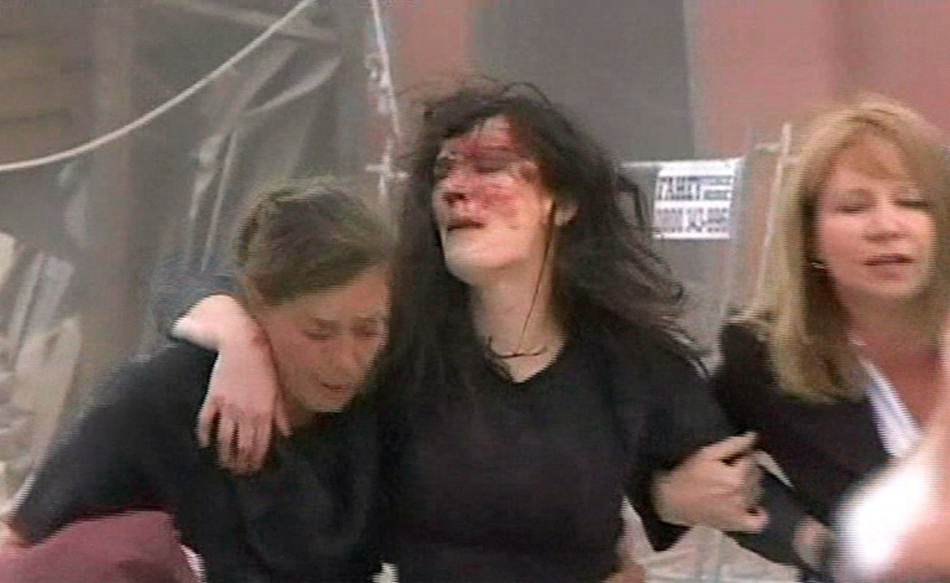 Earthquake in New Zealand (pictures): A wounded woman helped to safety after the New Zealand earthquake