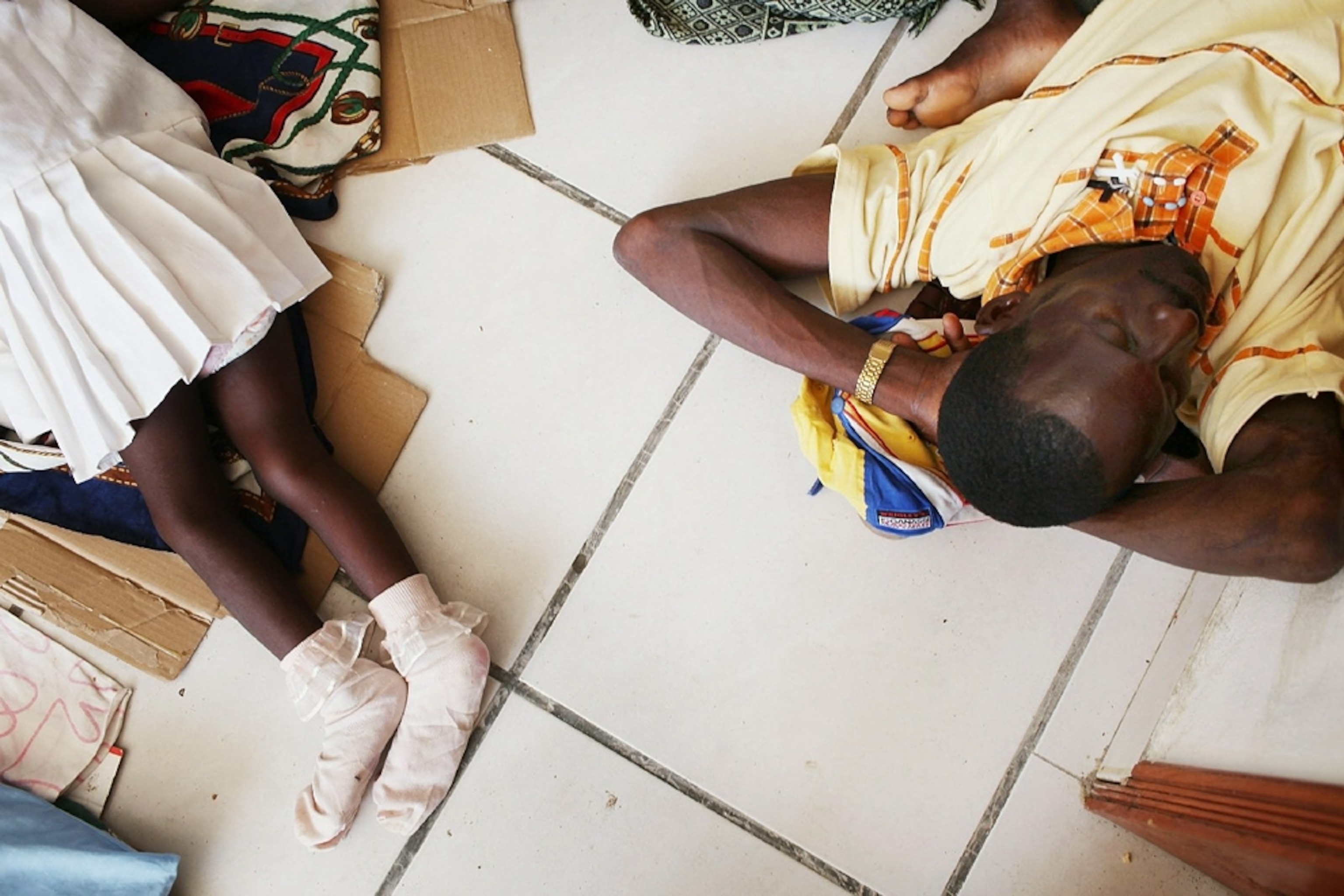 Cholera victims lie on a white tile floor -- picture from a photo gallery on the one-year Haiti-earthquake anniversary