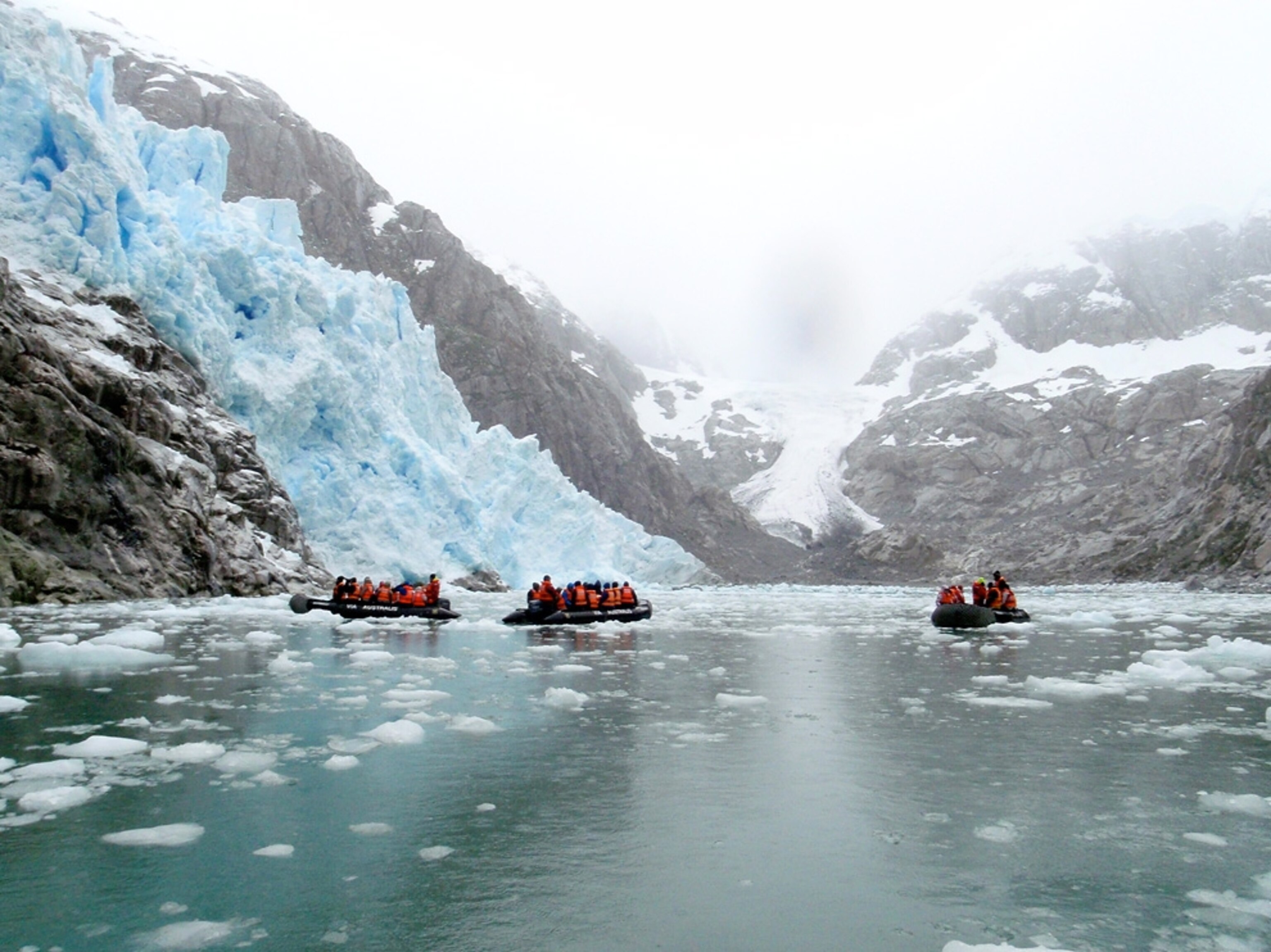 Zodiacs near a glacier