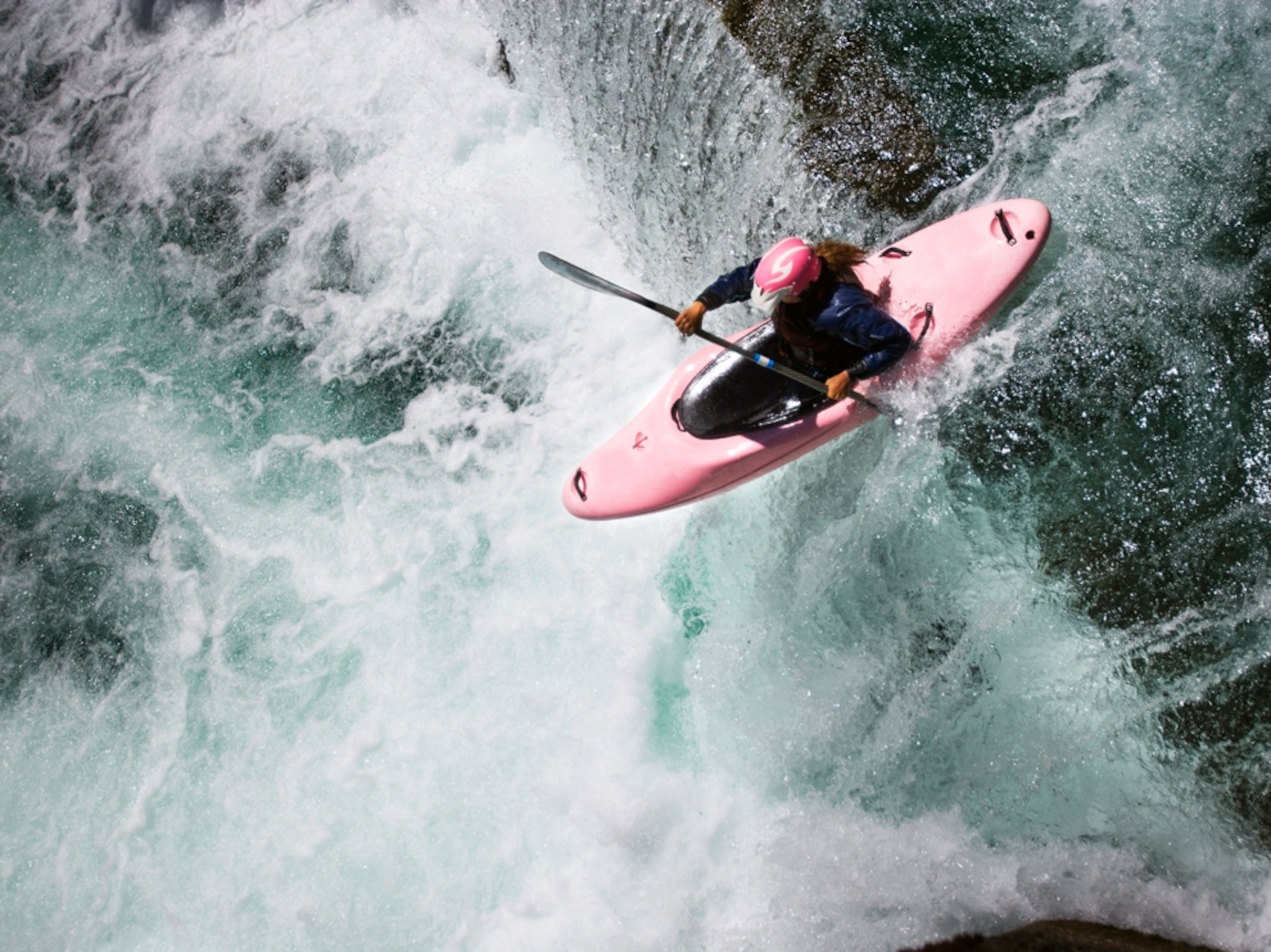 Kayaker going over waterfall