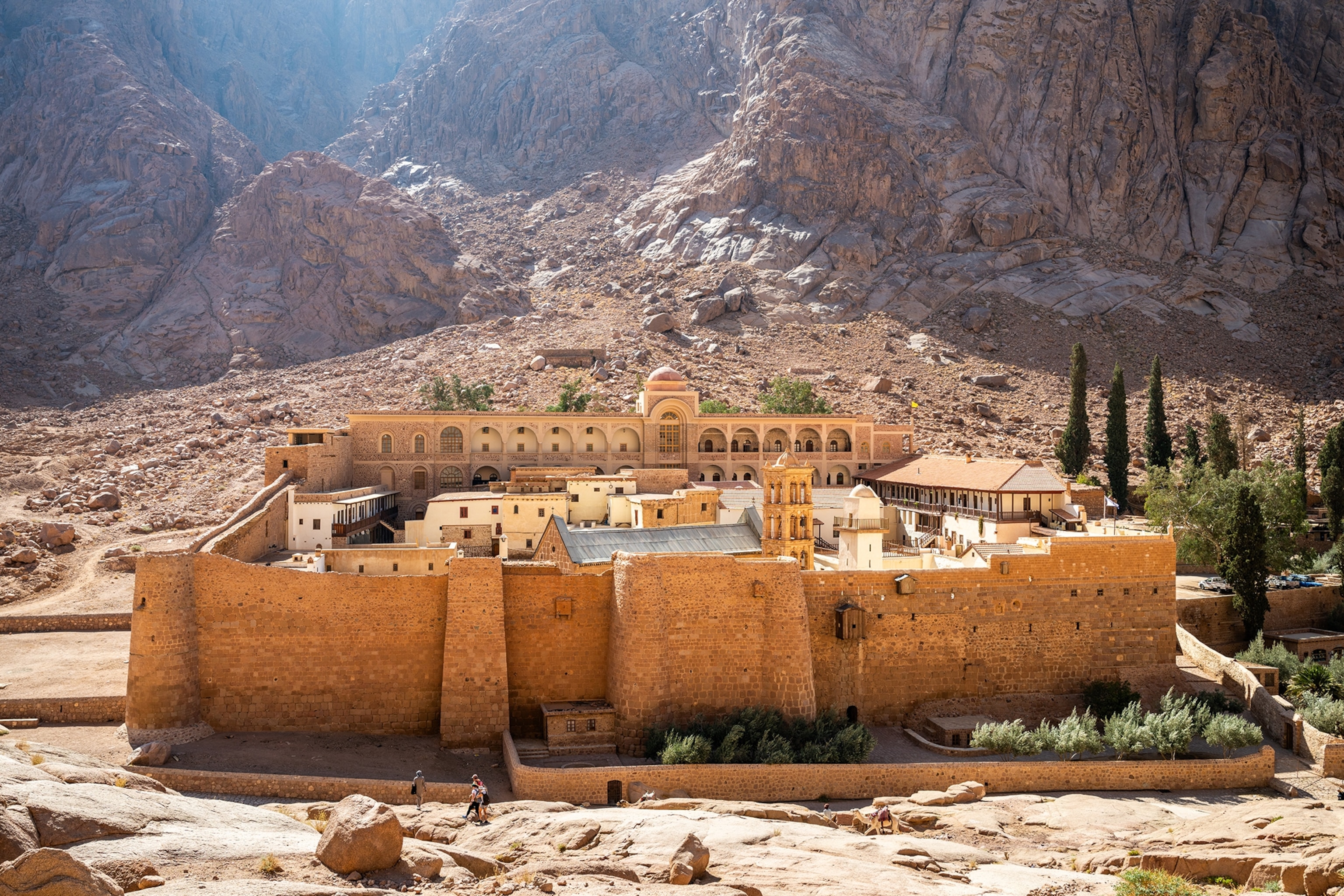 A fortified monastery at the foot of a mountain in Egypt's desert.