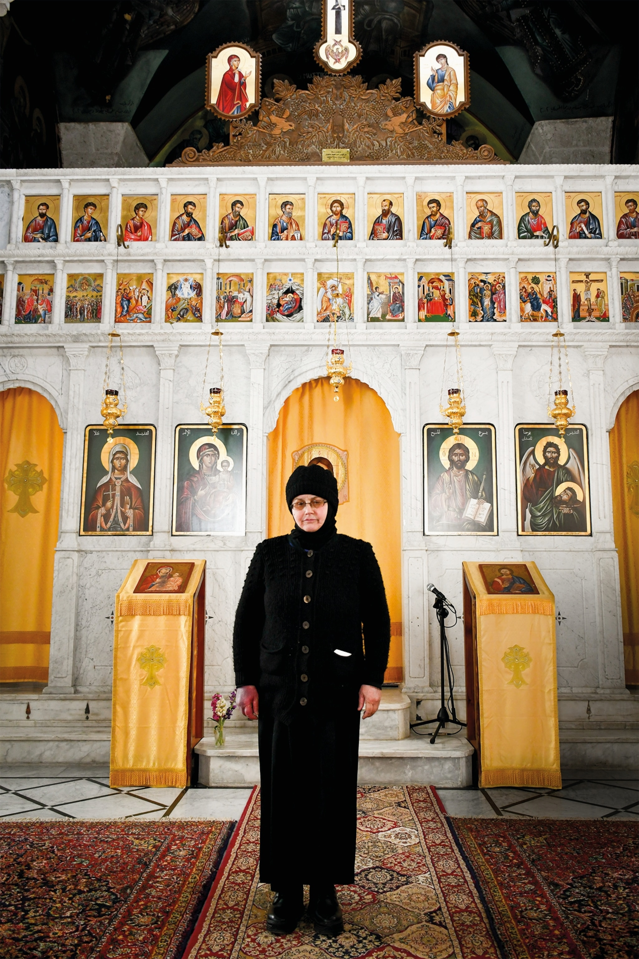 One of the 13 nuns kidnapped by Syrian rebels in 2013 and later released stands in her damaged church.