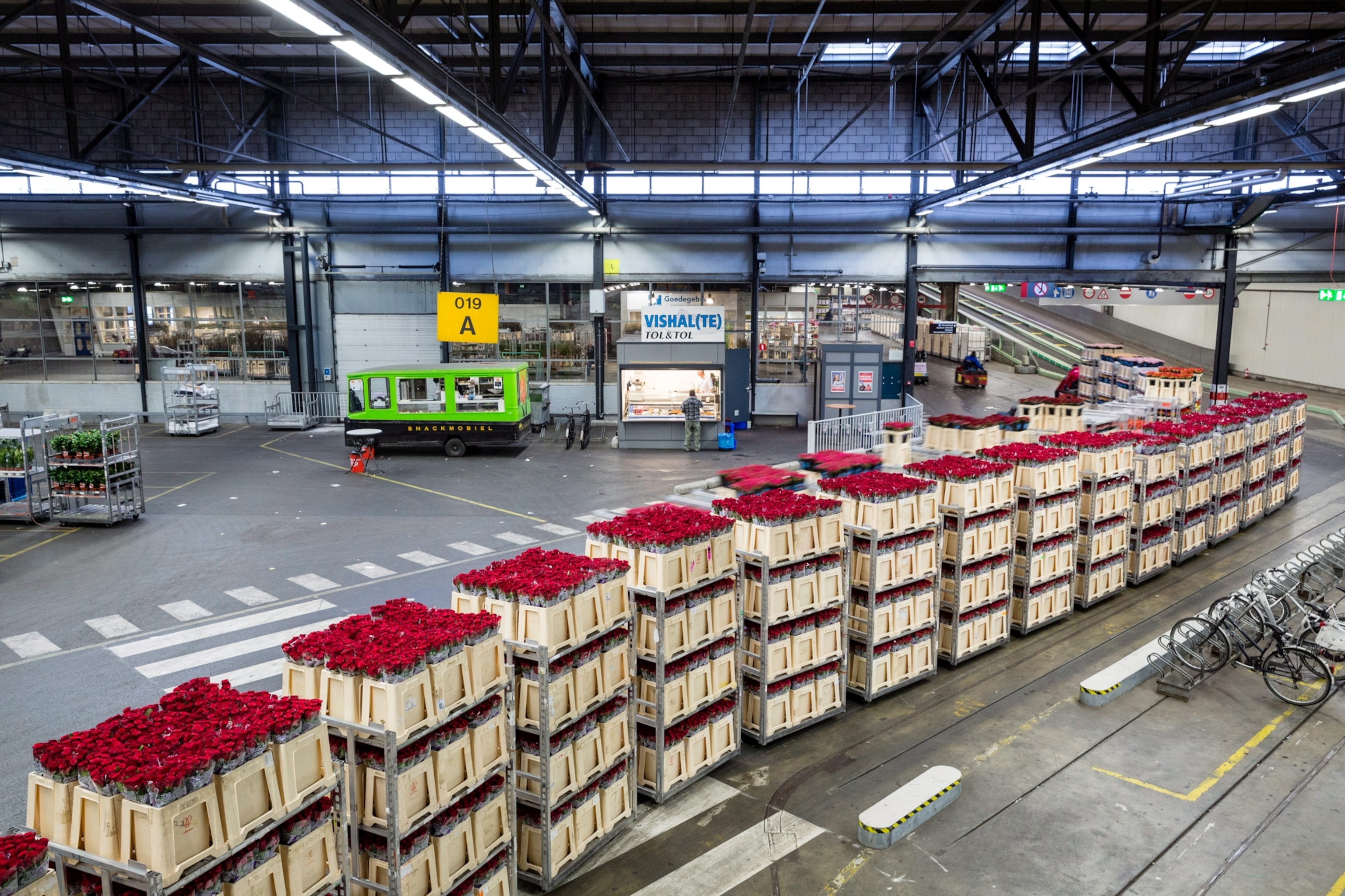 A stack of containers trailing into a warehouse.