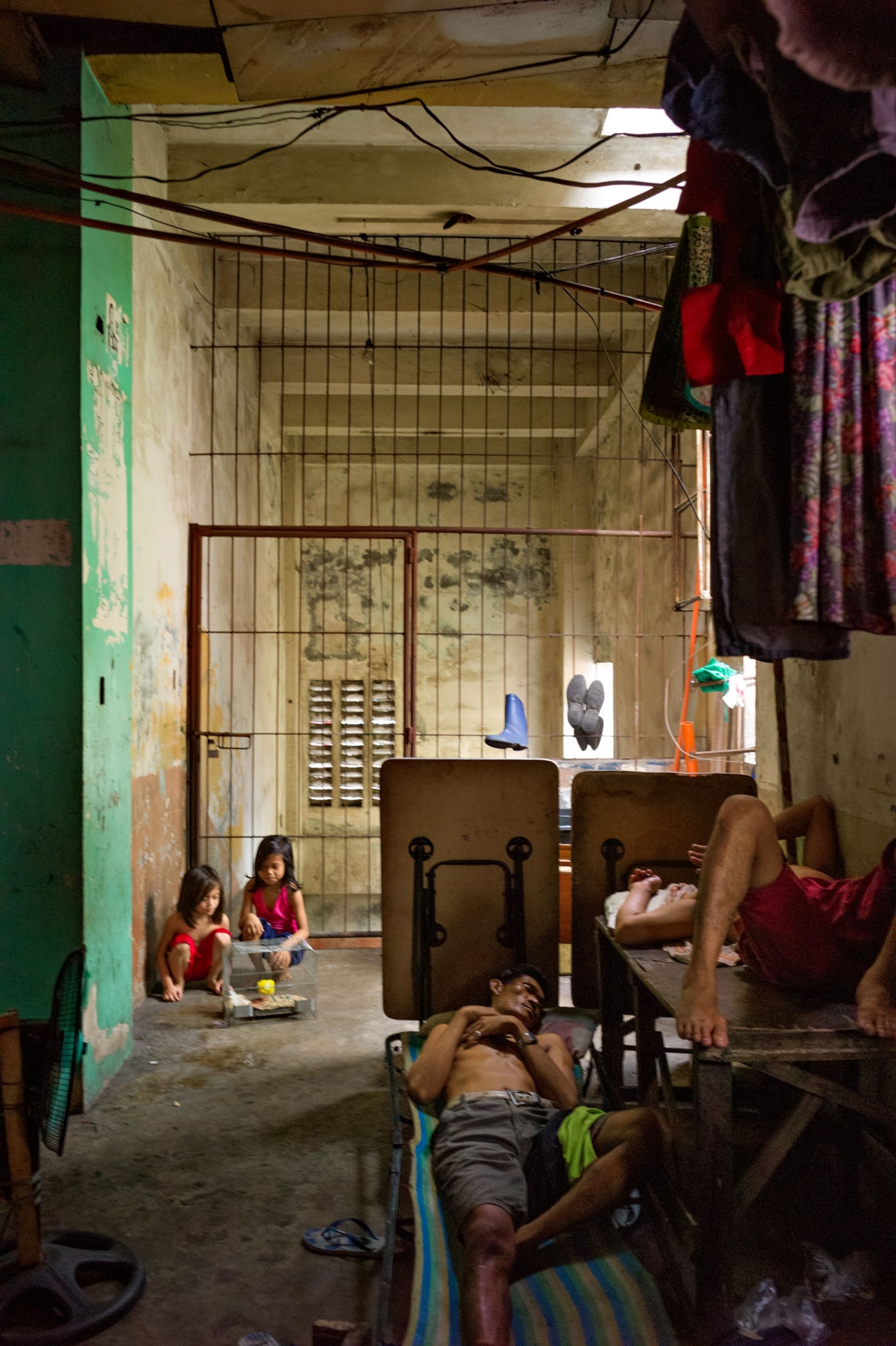 a man laying down and kids playing in the background