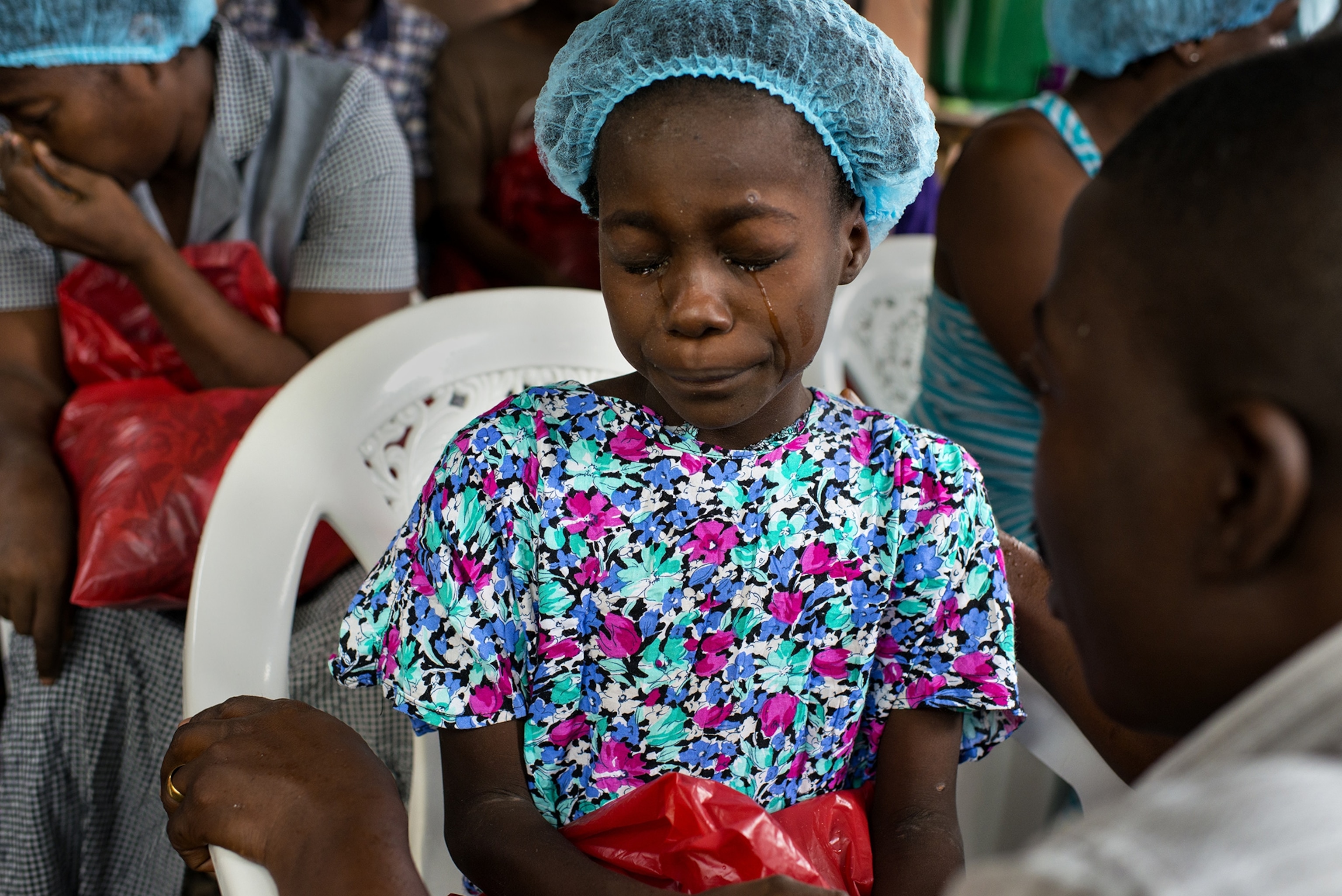 Esther Tokpah, 11 an orphan, weeps as Dr. Jerry Brown tries to console her before she was released from care on Wednesday September 24, 2014 in Monrovia Liberia.