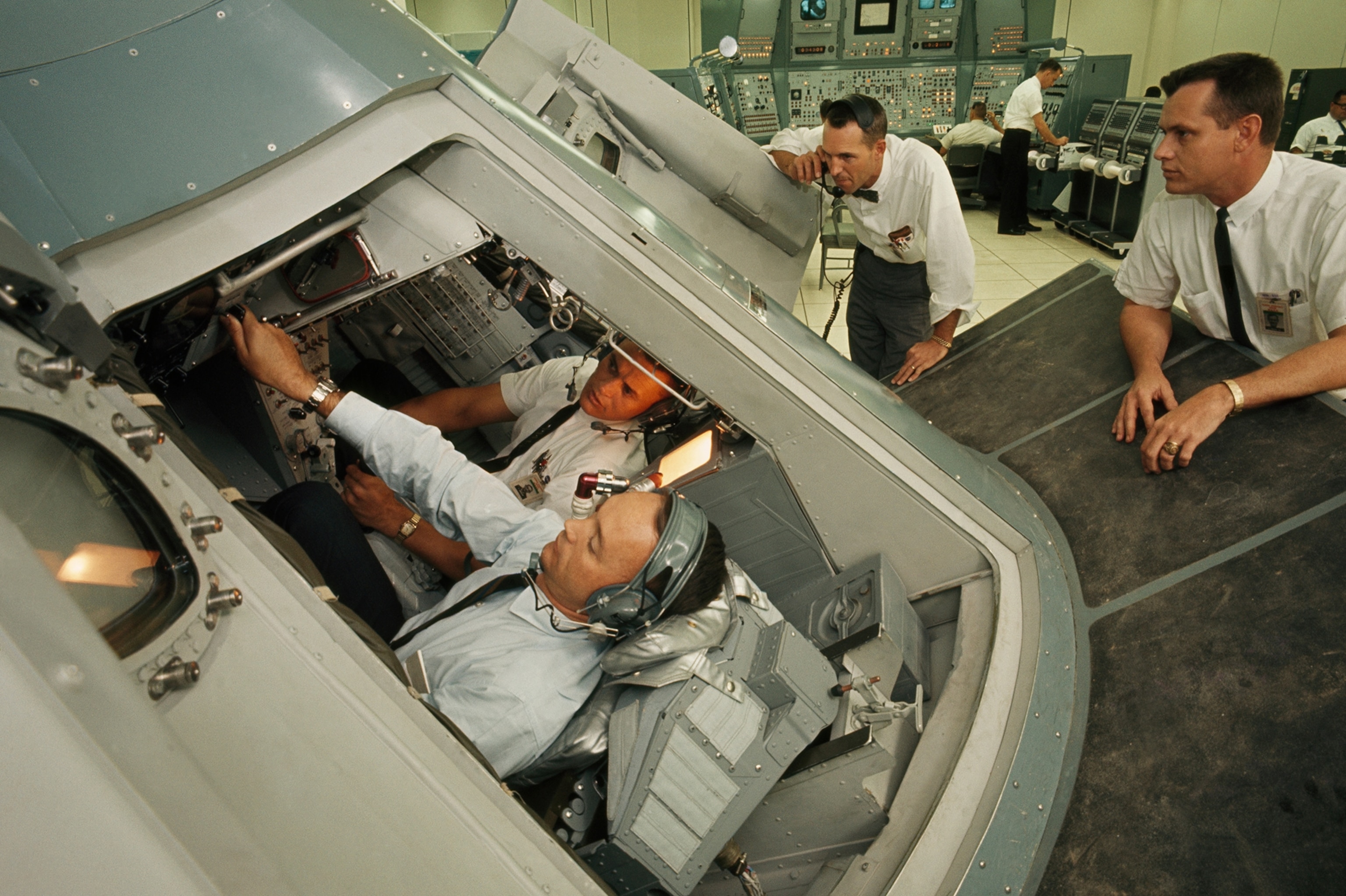 Astronauts study rocks and surveying to prepare for a moon landing.