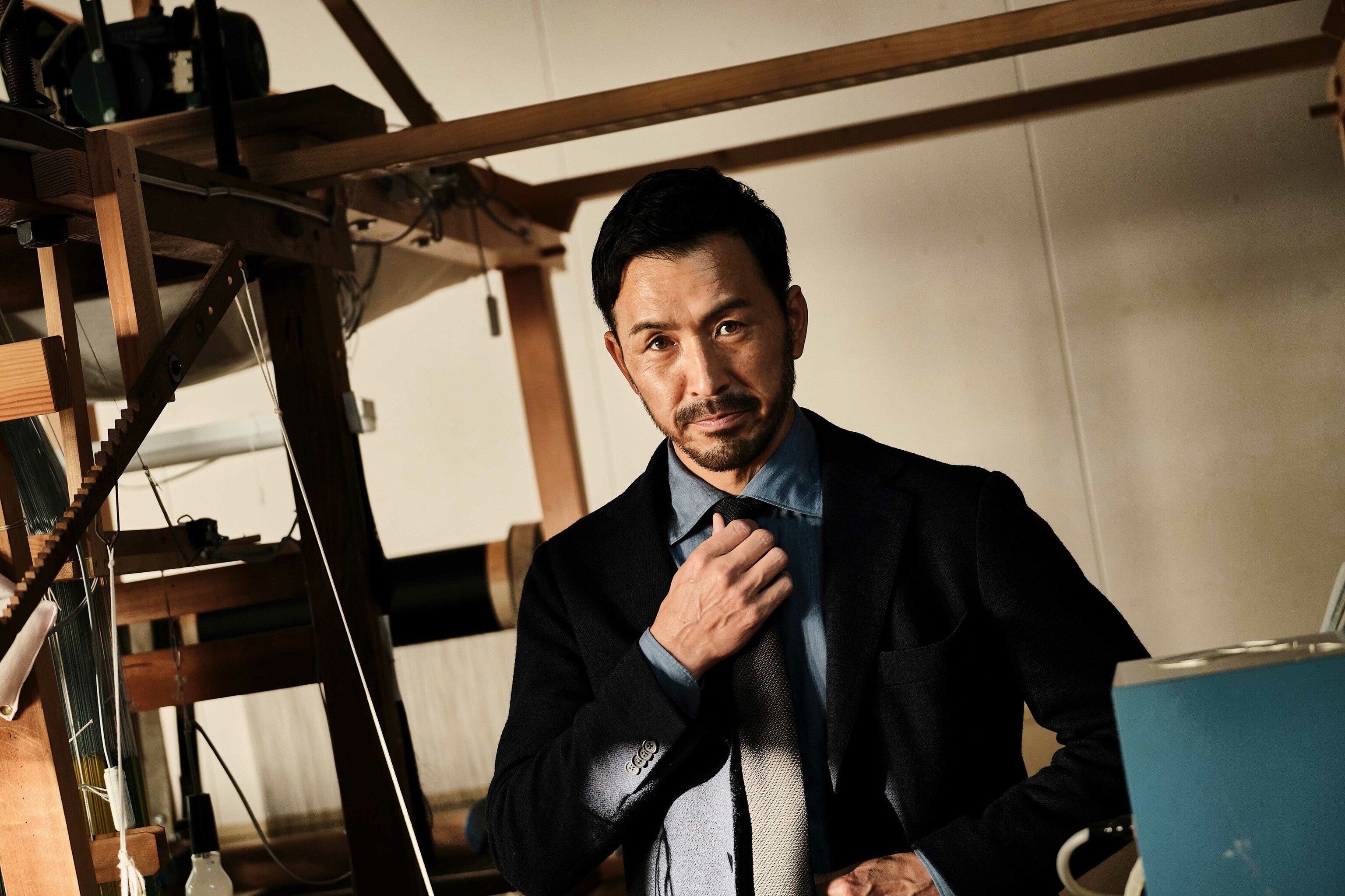 A man doing up a tie.