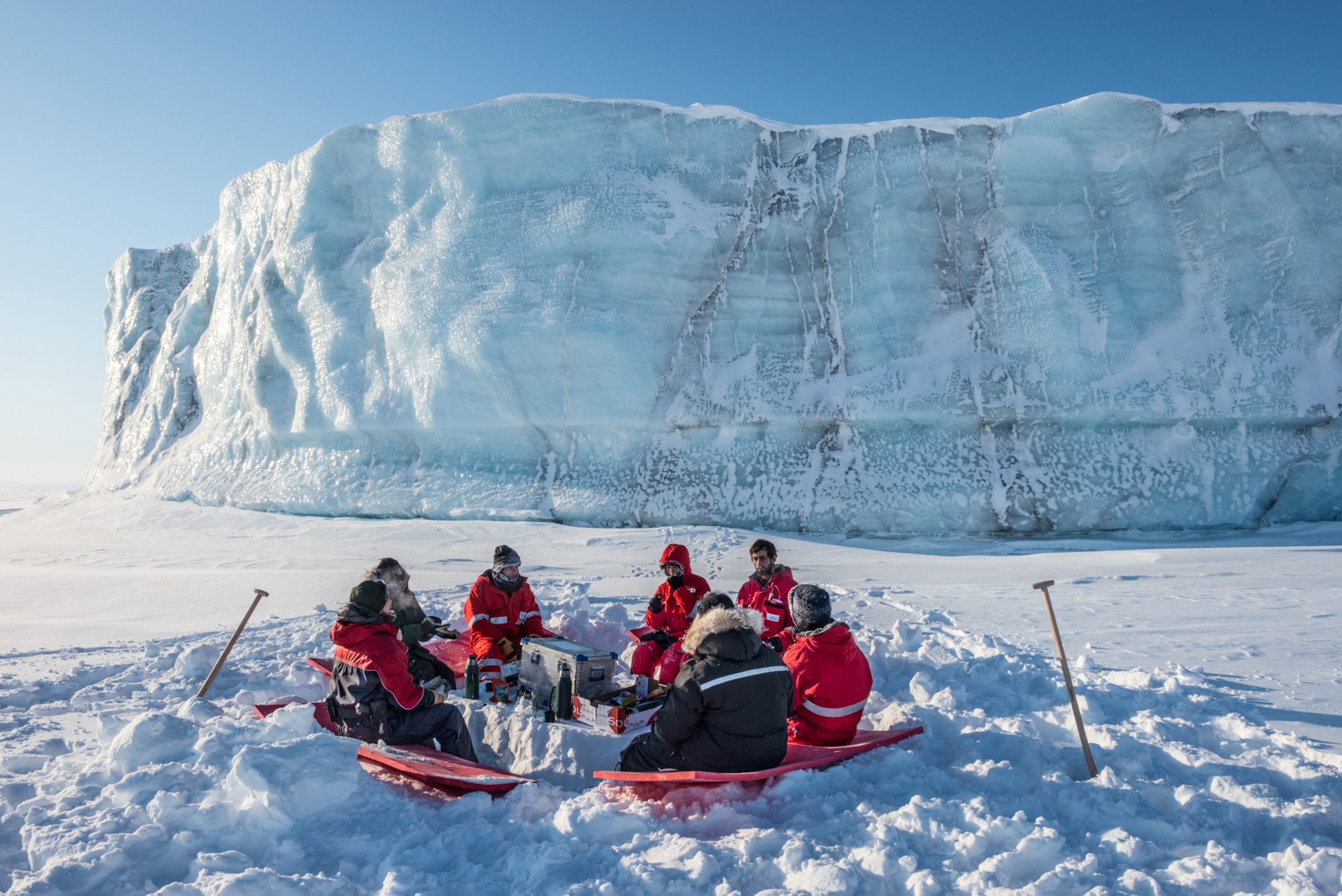A group of people have lunch in the cold.