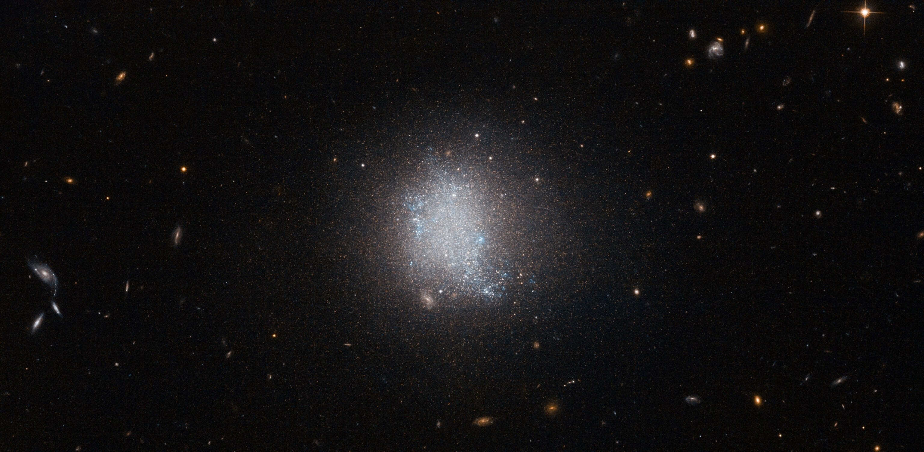 smudge of stars at the center of this image is a galaxy known as UGC 5797