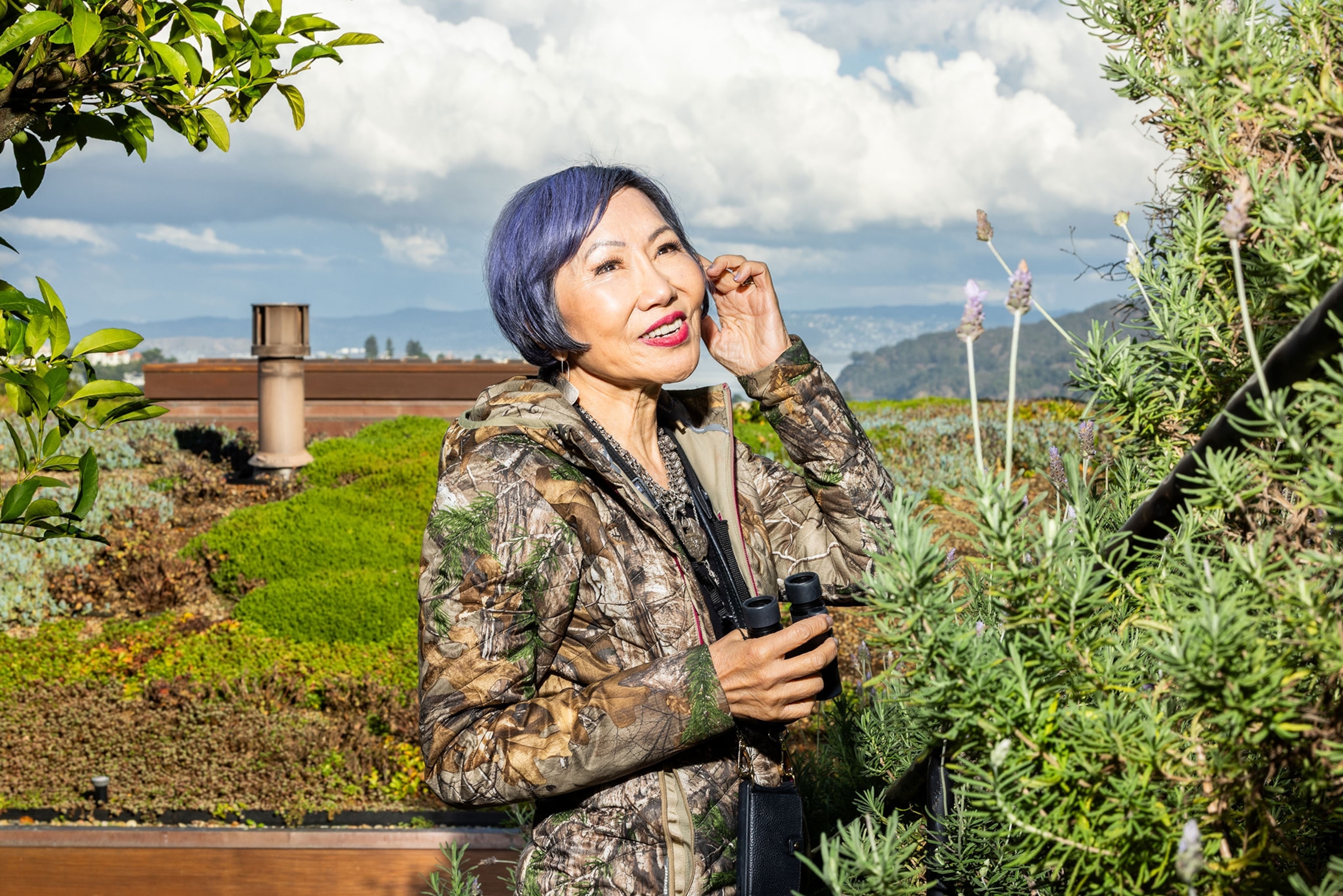 A woman with blue hair, and camo.