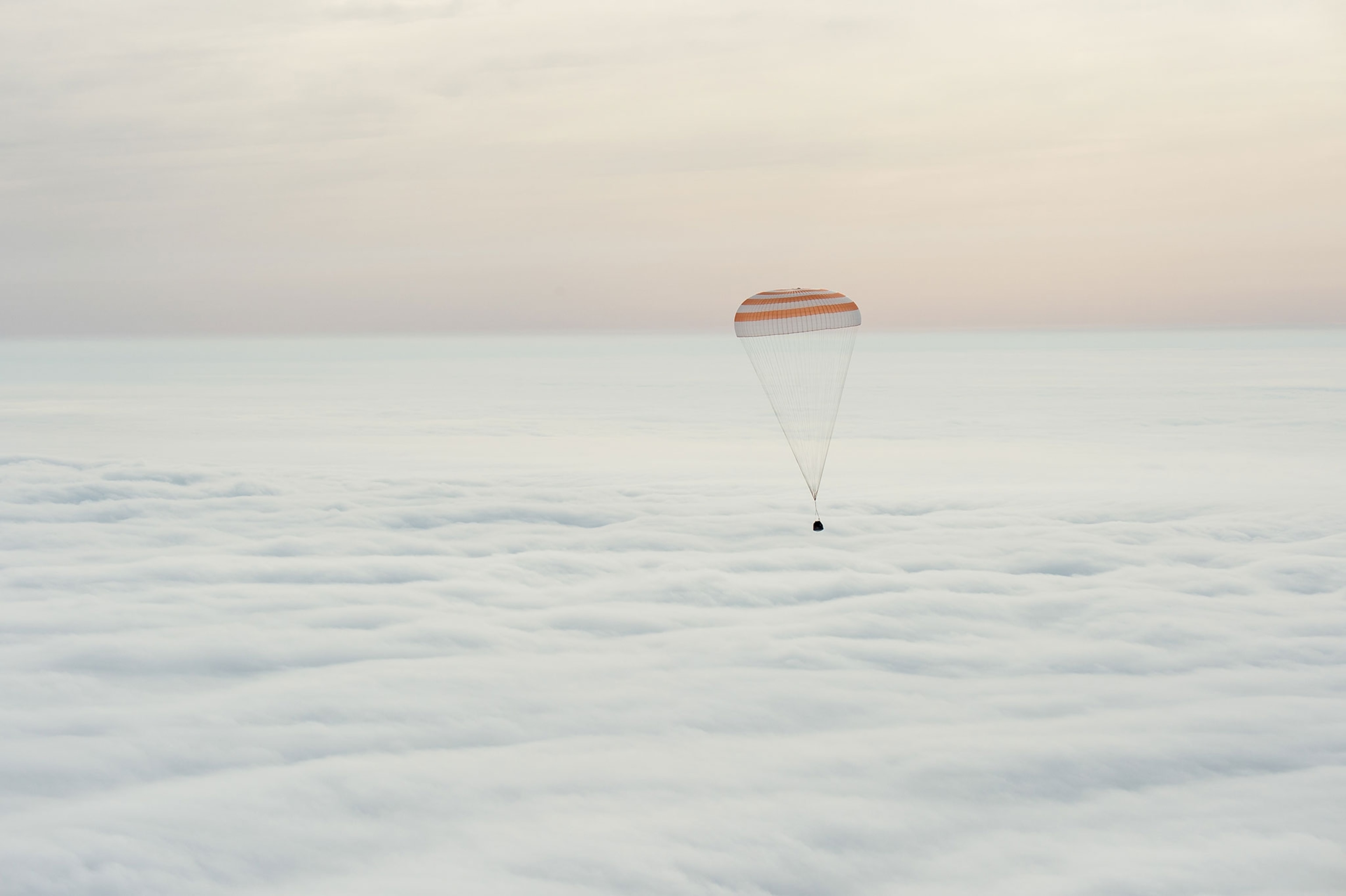 parachute and spacecraft falling to ground