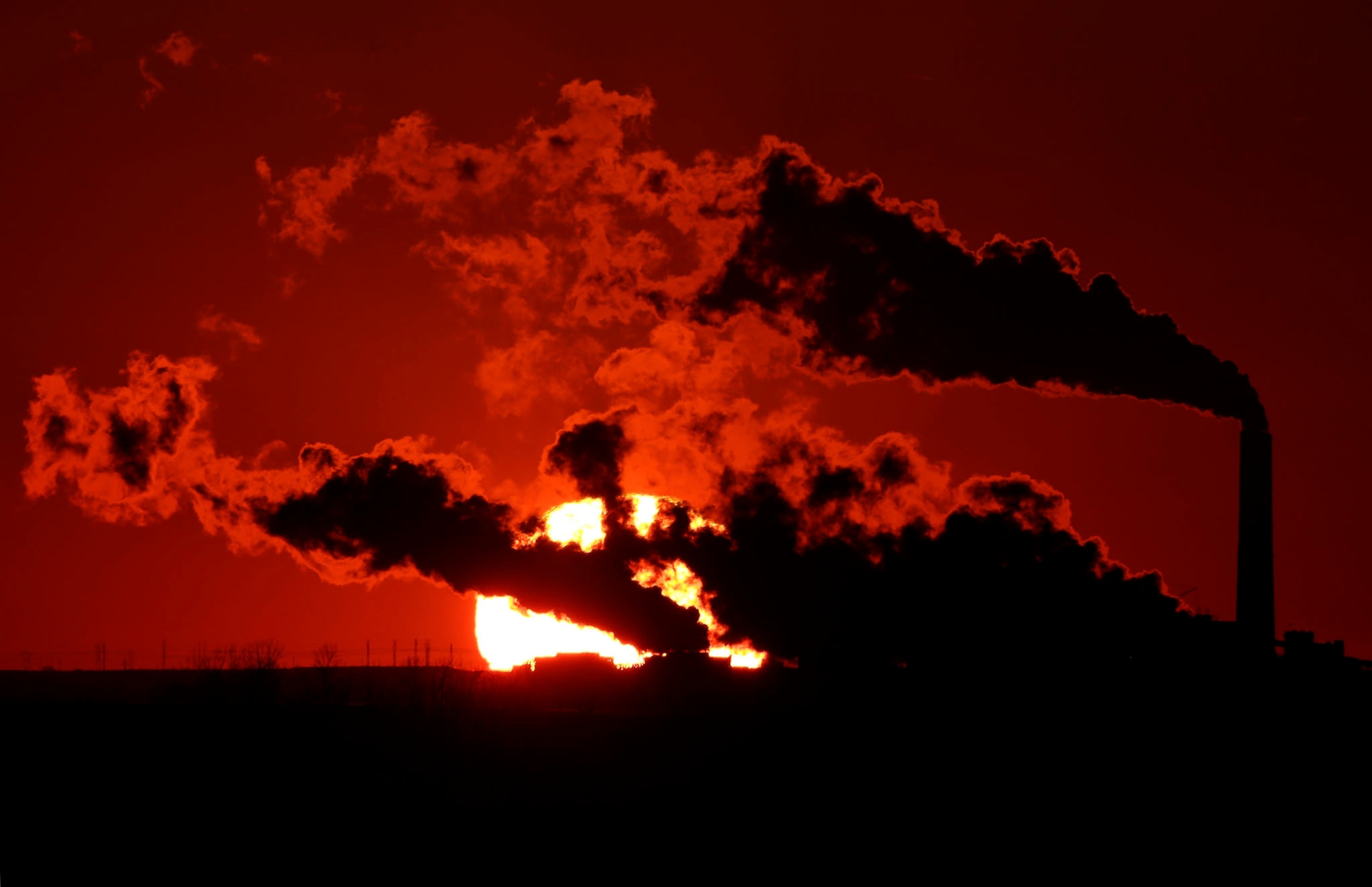 In this March 8, 2014 file photo steam from the Jeffrey Energy Center coal-fired power plant is silhouetted against the setting sun near St. Marys, Kan.