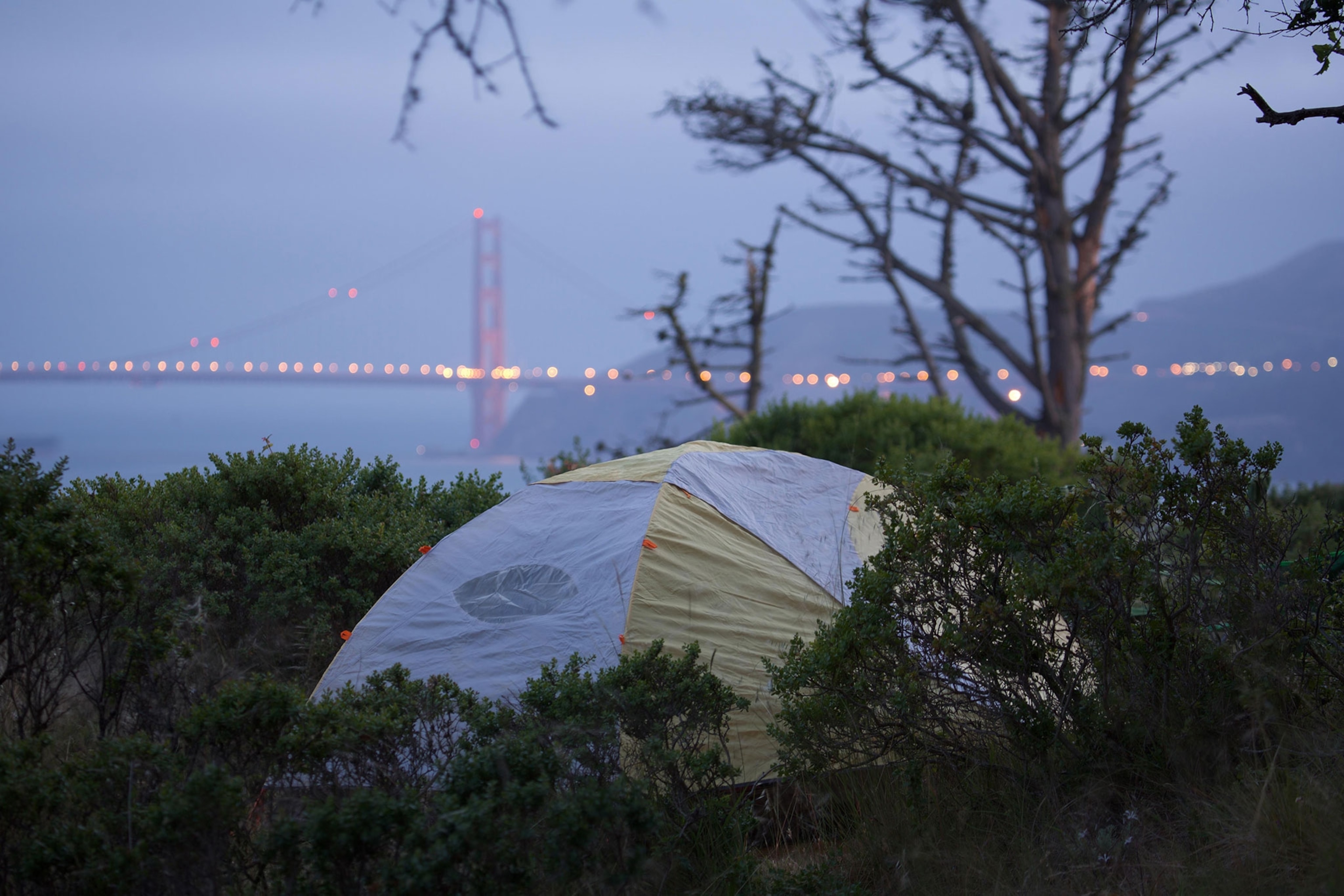 a camping tent with a view of San Francisco in the background