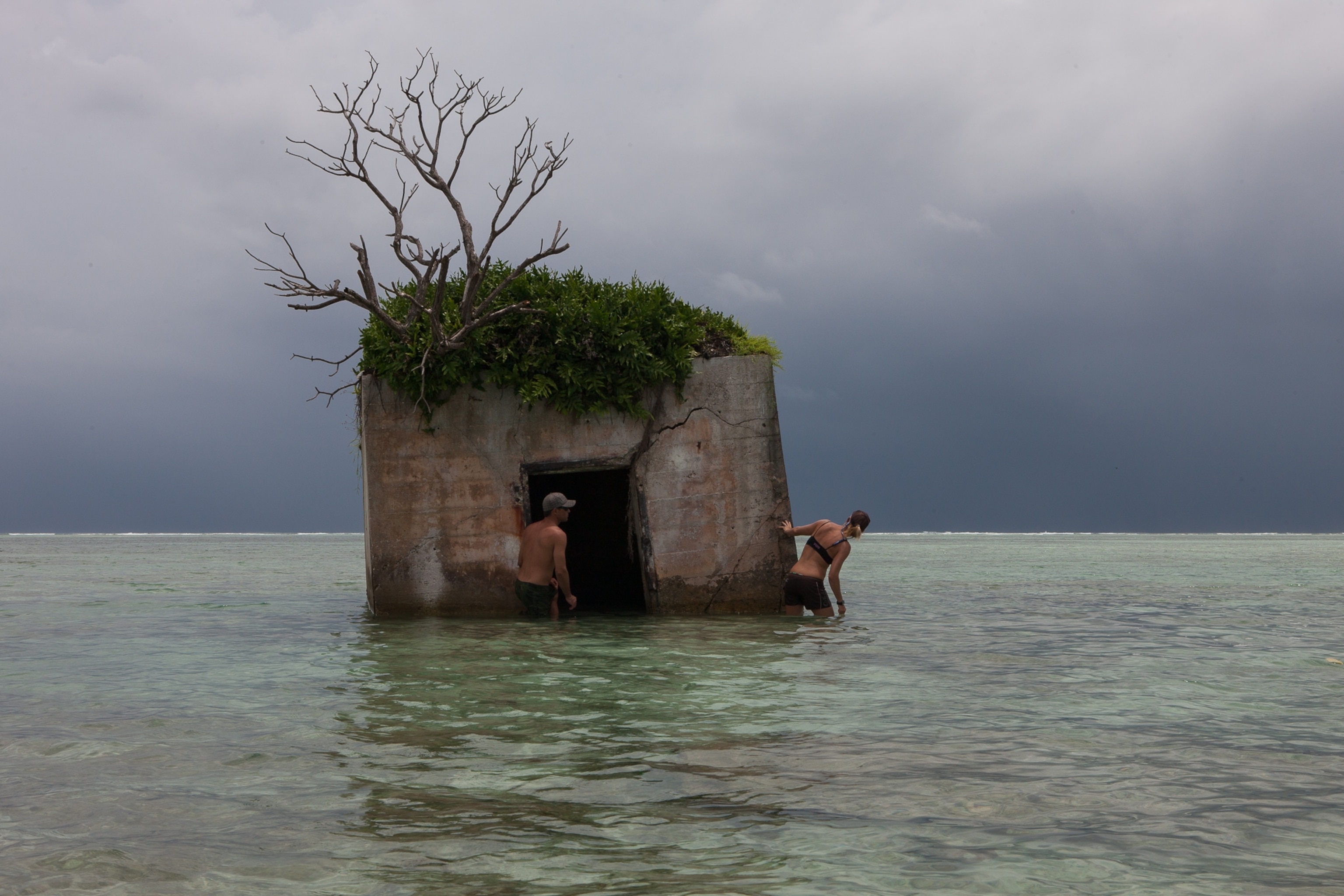 Kydd Pollock, Science Specialist at The Nature Conservancy, and Amanda Meyers, Palmyra Atoll Refuge Manager, examine the roof of a US Department of the Navy bunker, between Quail Island and Whippoorwill Island on the north east end of Palmyra Atoll.