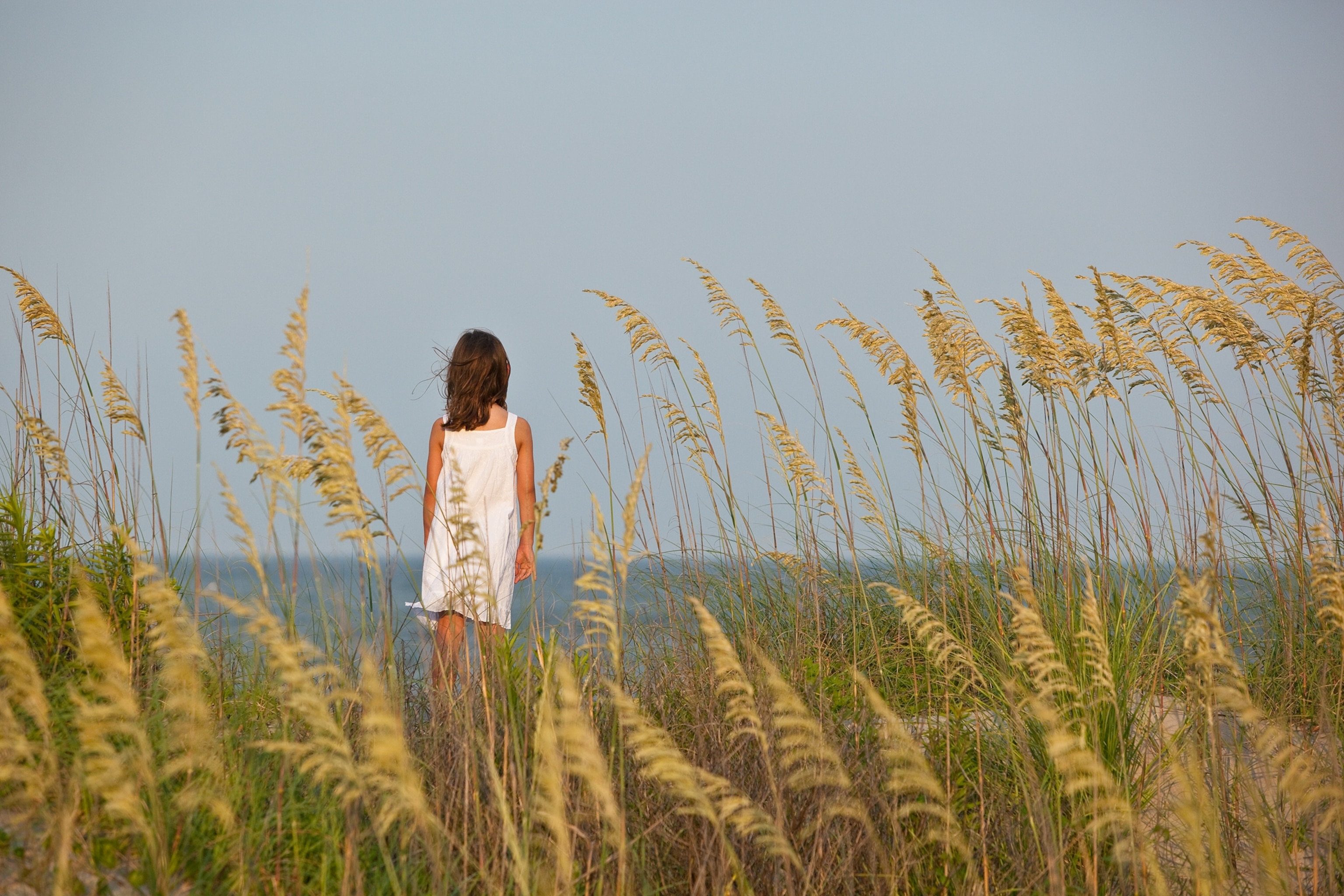 a young girl looking at the Atlantic ocean.