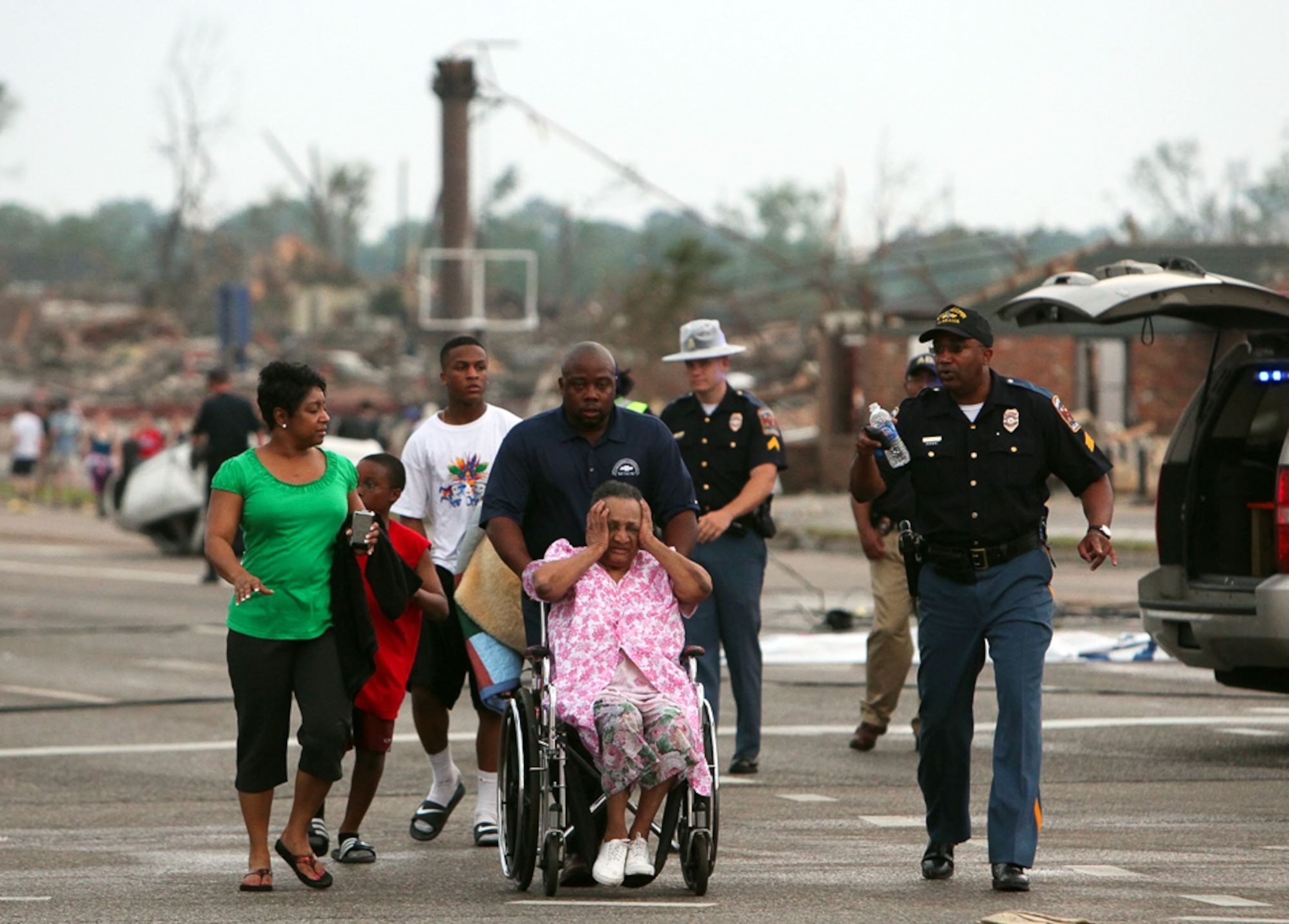 Alabama tornado picture: responders helping a displaced family in Tuscaloosa, where a huge twister made Alabama news headlines