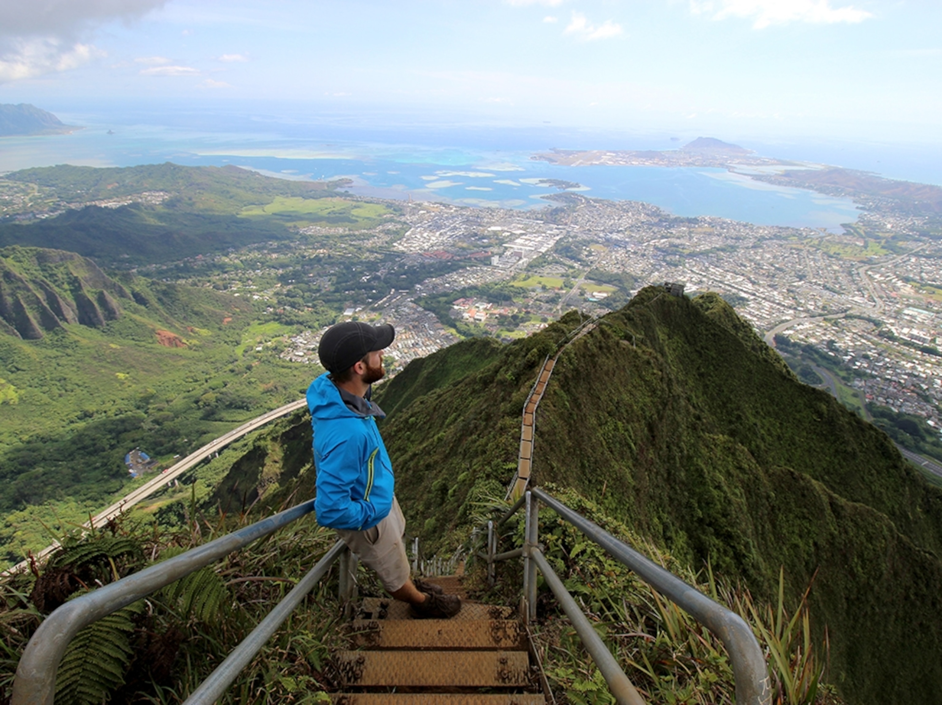 a man taking in the jaw-dropping view from the famed Haiku Steps in Honolulu, Hawaii
