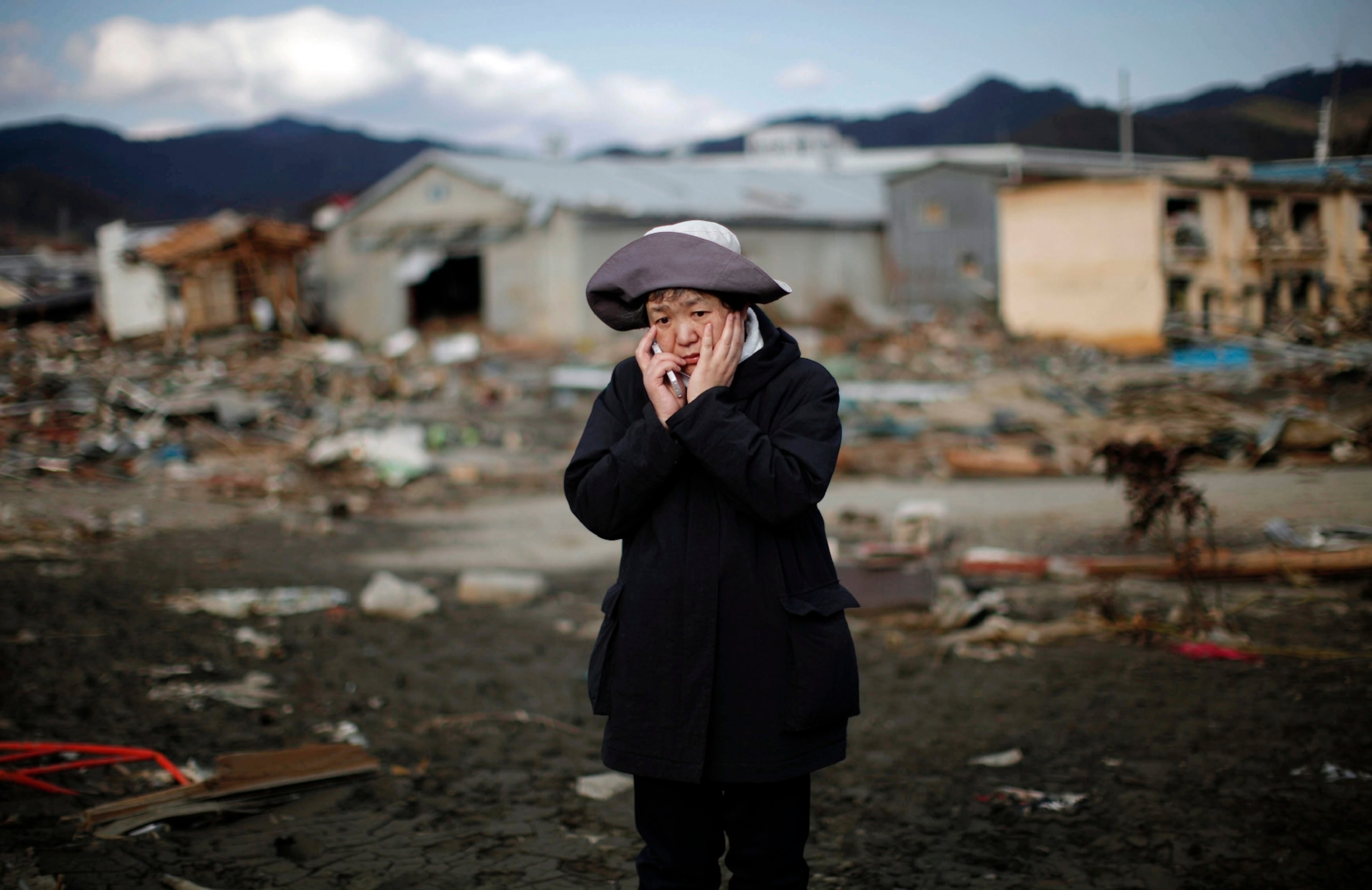 a woman on a phone in Japan after an earthquake