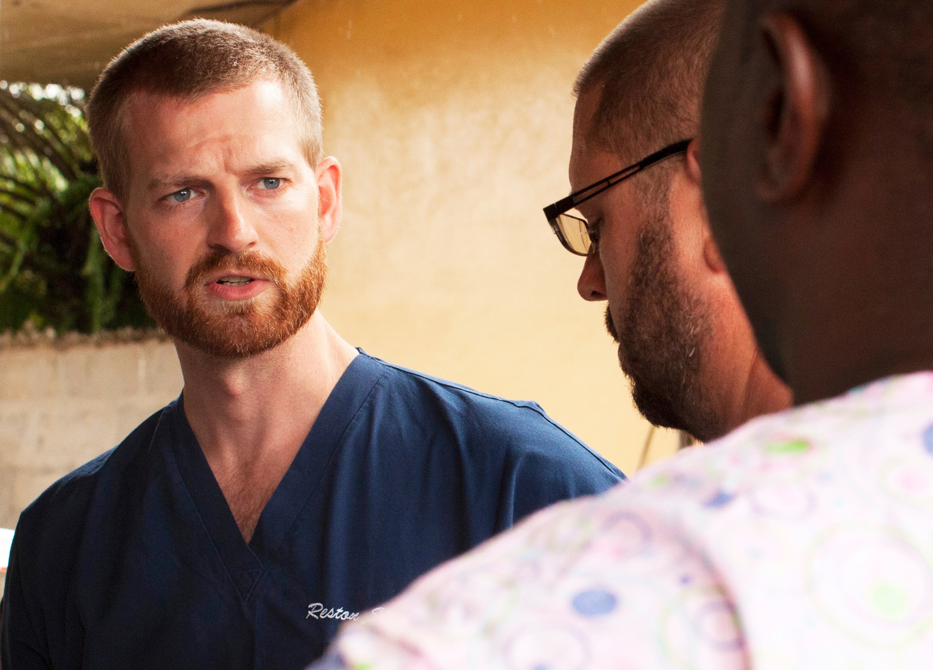 A handout photo provided by Samaritan's Purse on 01 August 2014 shows Dr. Kent Brantly (R) working at an Ebola treatment clinic in Foya, Liberia, 23 June 2014.