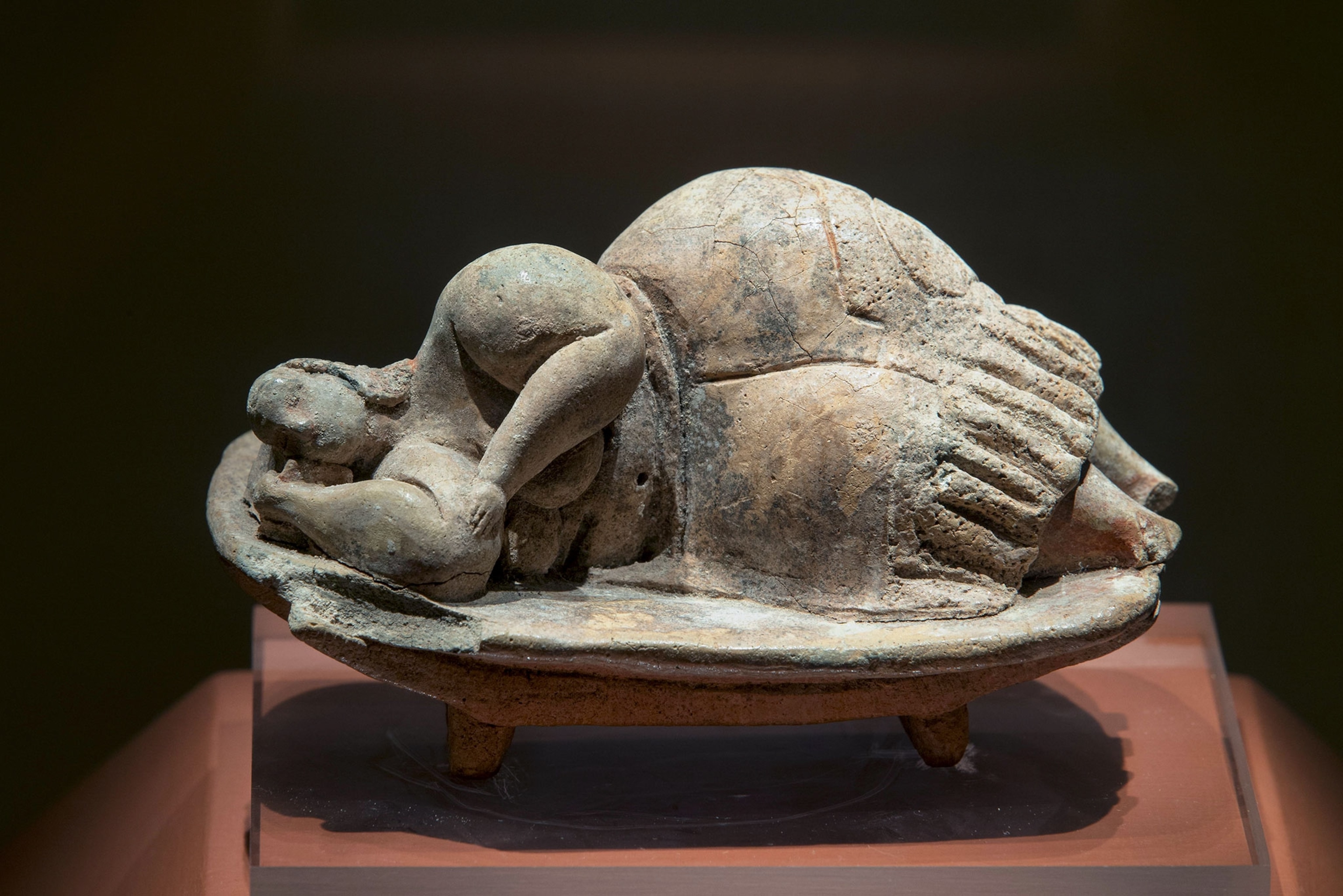 A statue of a woman horizontal it is made of a hard material.