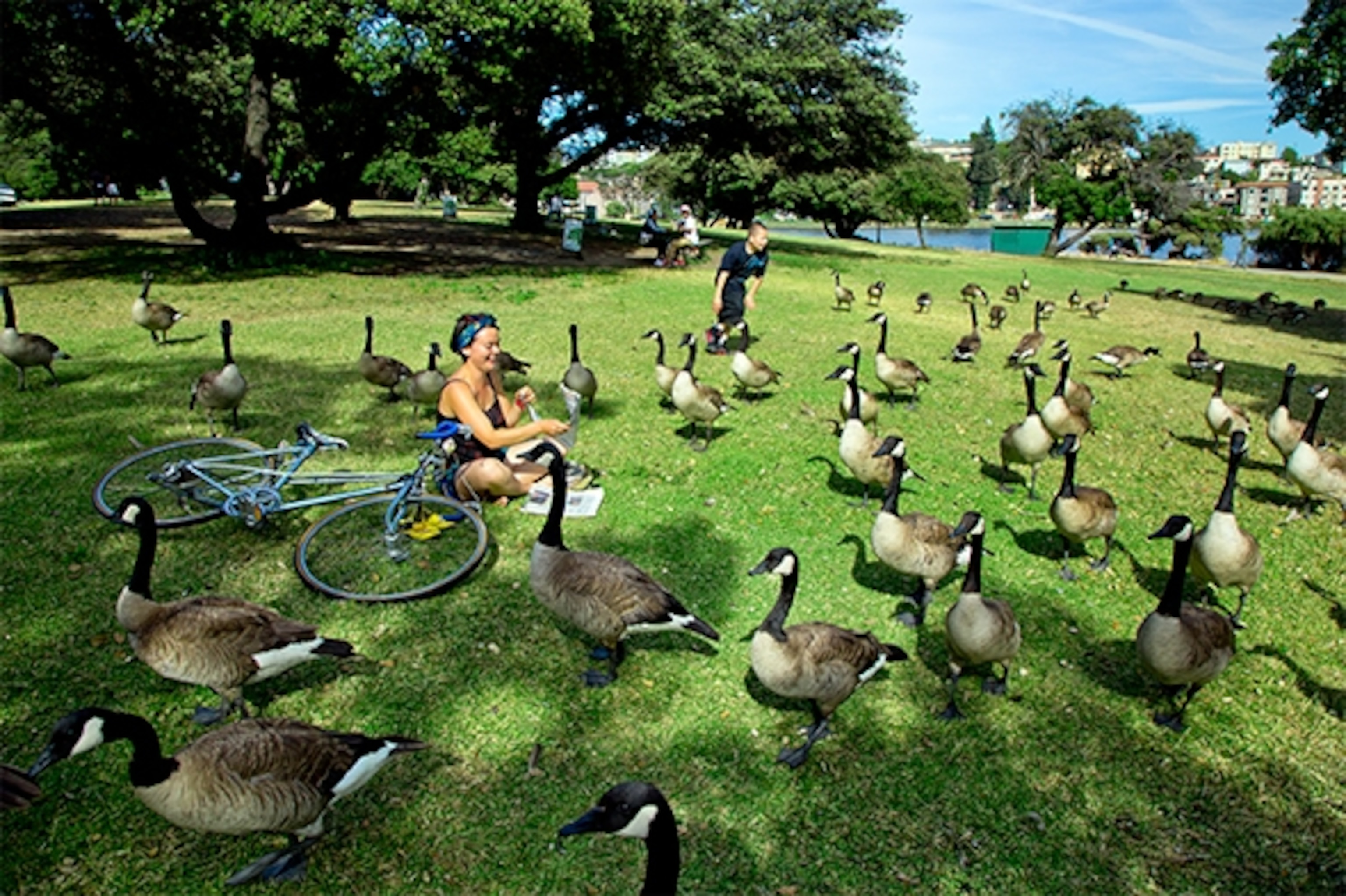 At Lake Merritt, Robyn Kick relaxes after a day of volunteering at an organic farm that donates produce to Oakland residents in need. (Photograph by Catherine Karnow)
