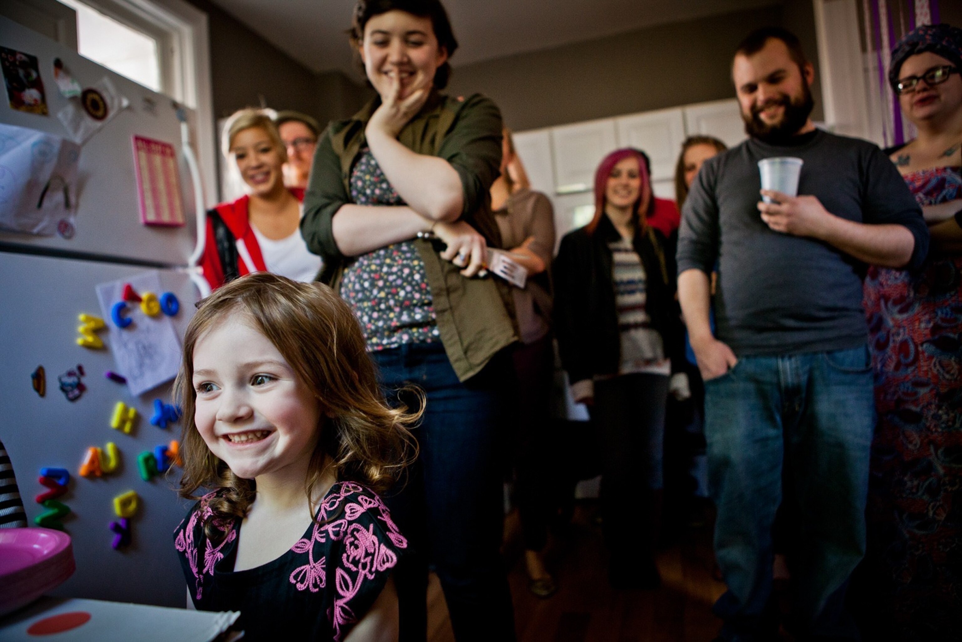 a young child smiling at a birthday party