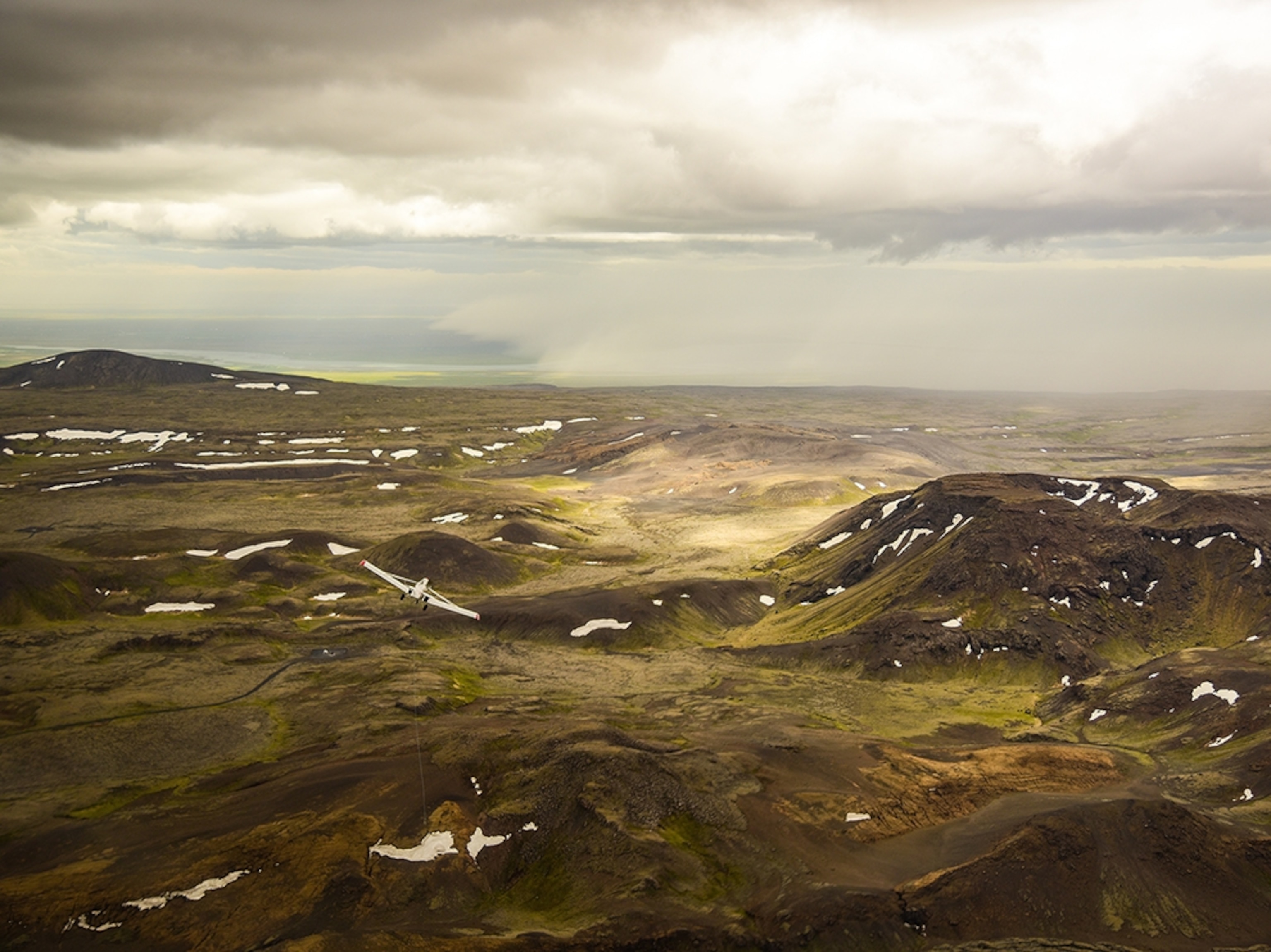 a plane flying over the Iceland landscape