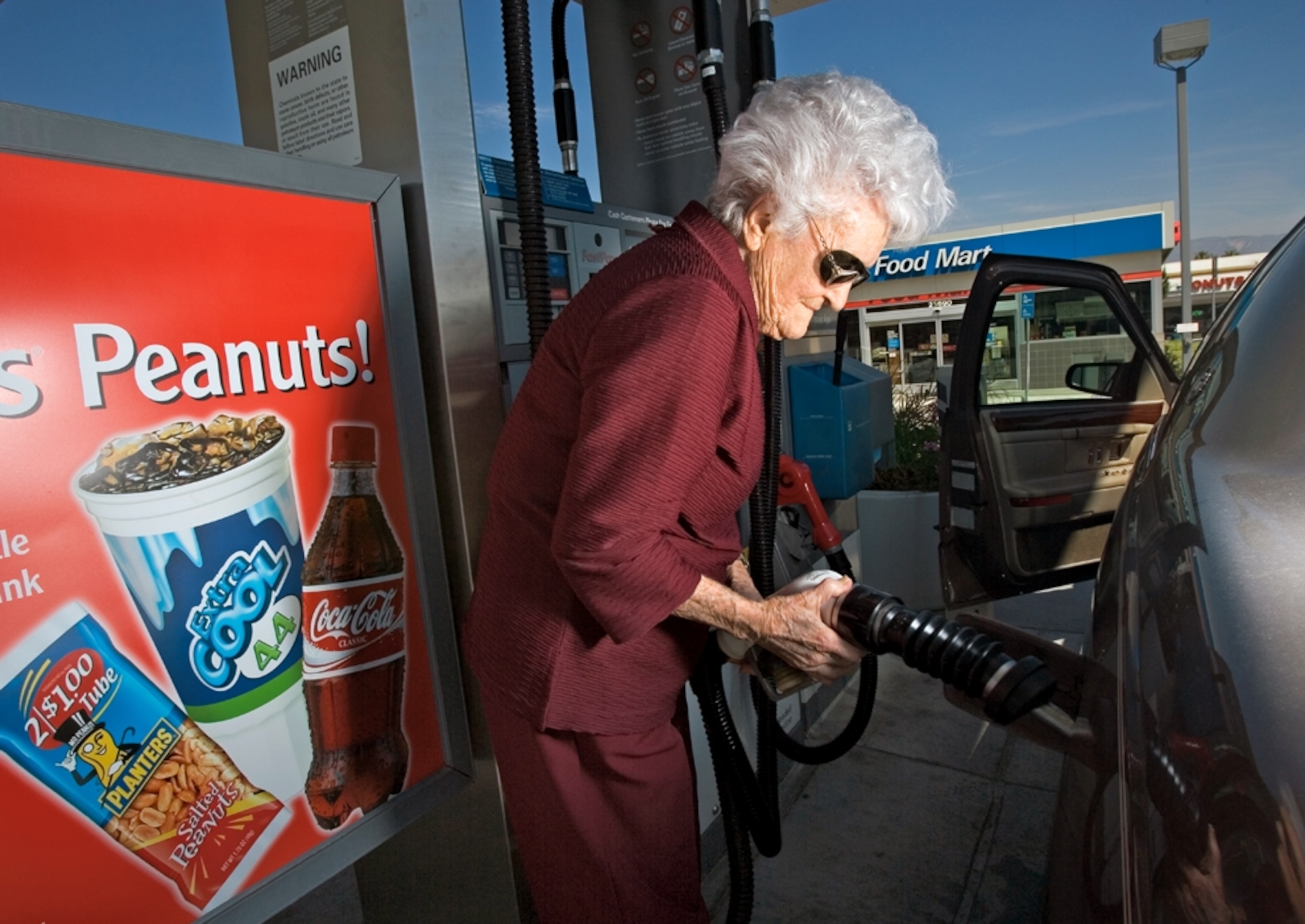 Woman pumps gasoline in Lomo Linda, California