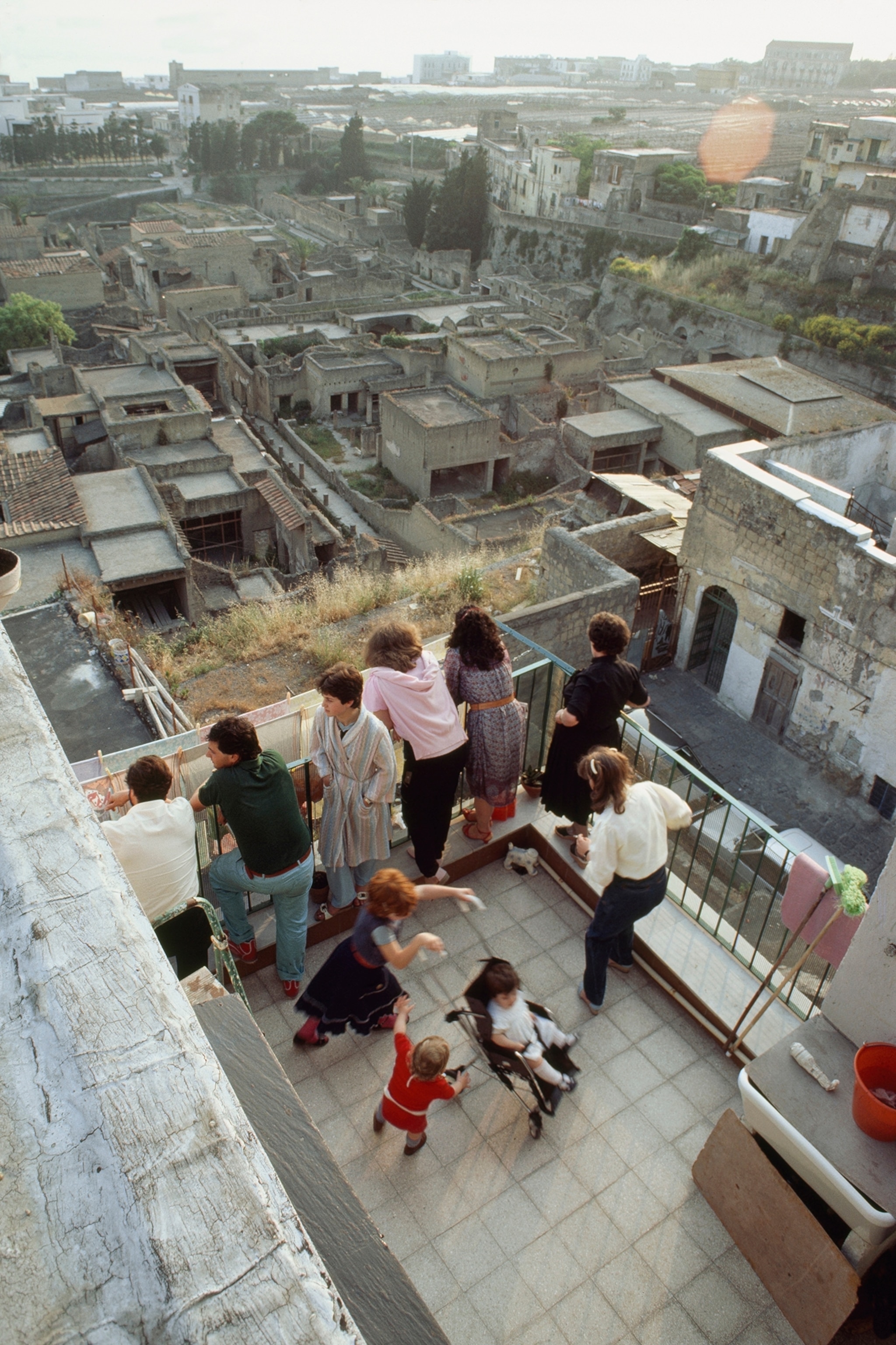 Residents of Ercolano enjoy their view of the ancient city's ruins.