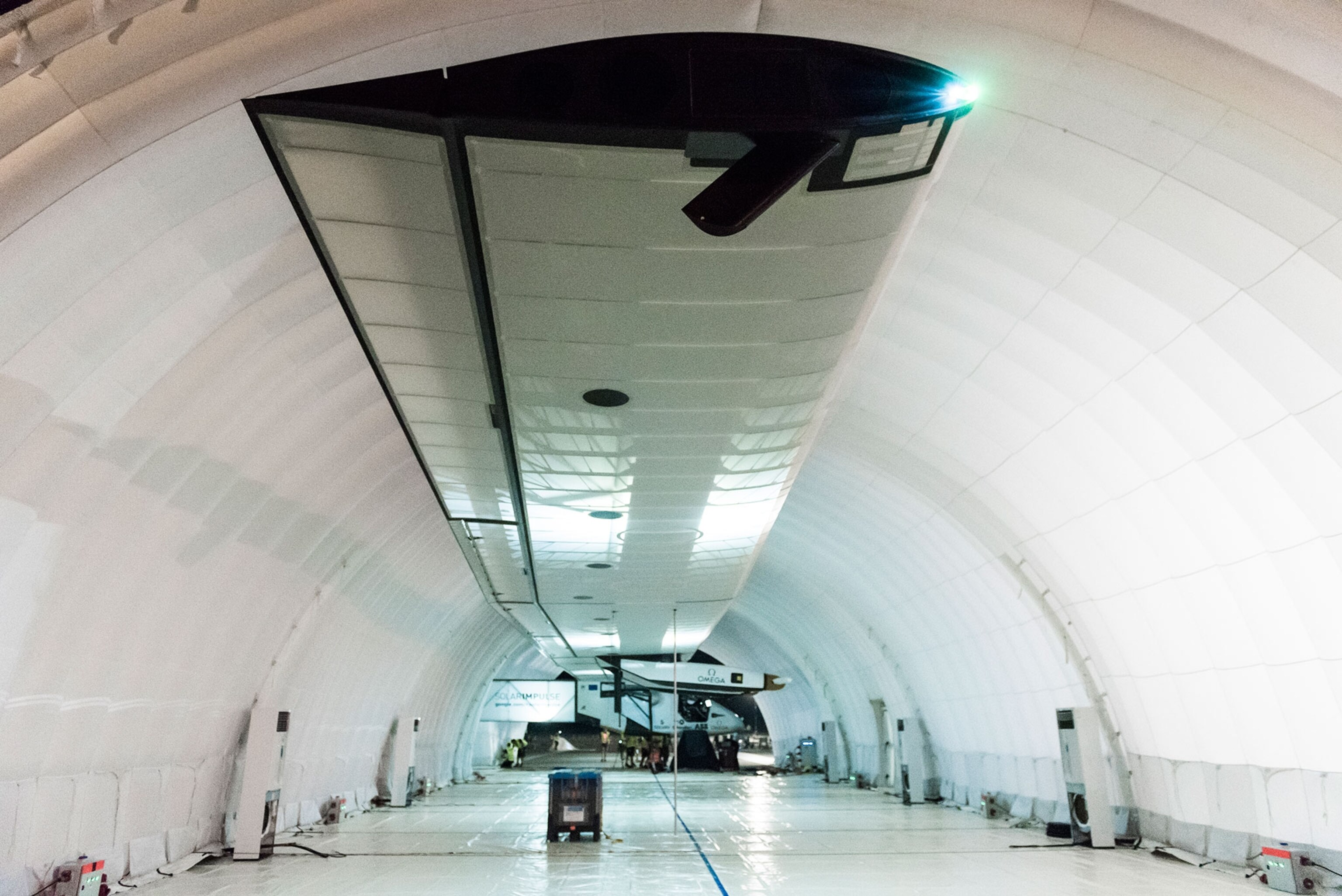 Solar Impulse plane wing in mobile hangar in Mandalay