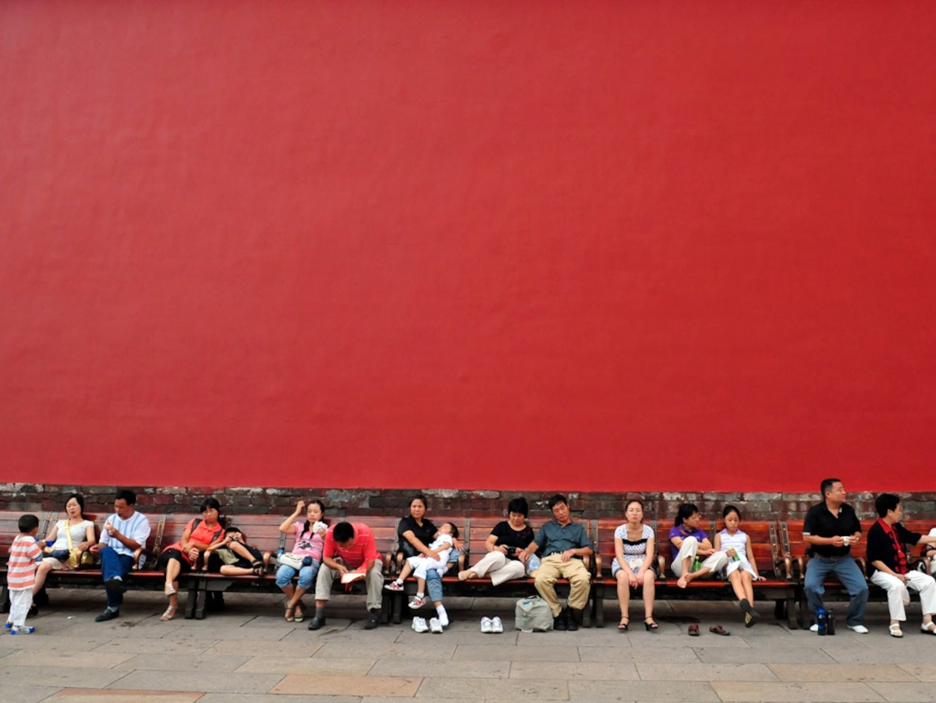 Crowds sitting on benches in Beijing