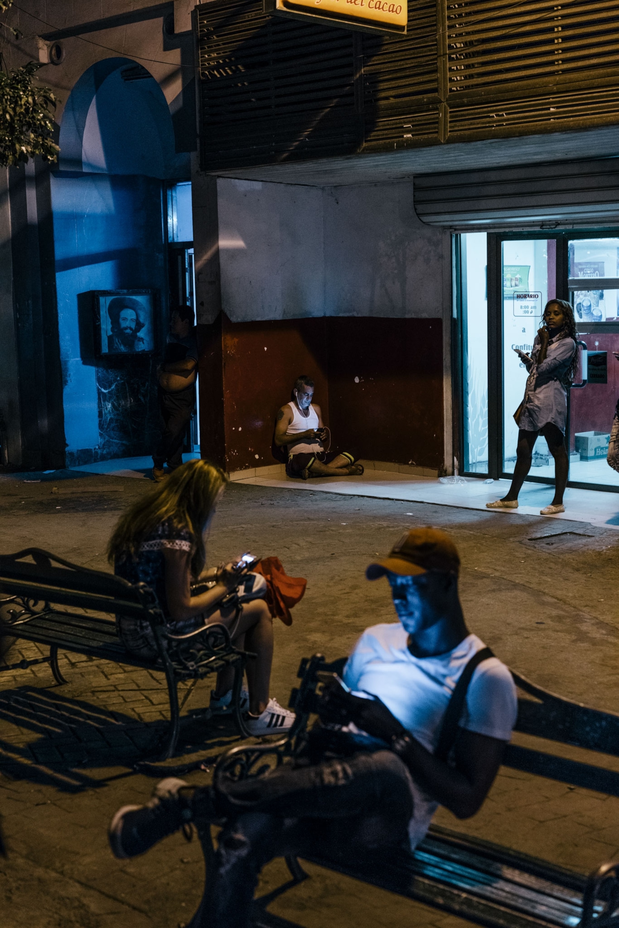 people checking their phone in Havana, Cuba
